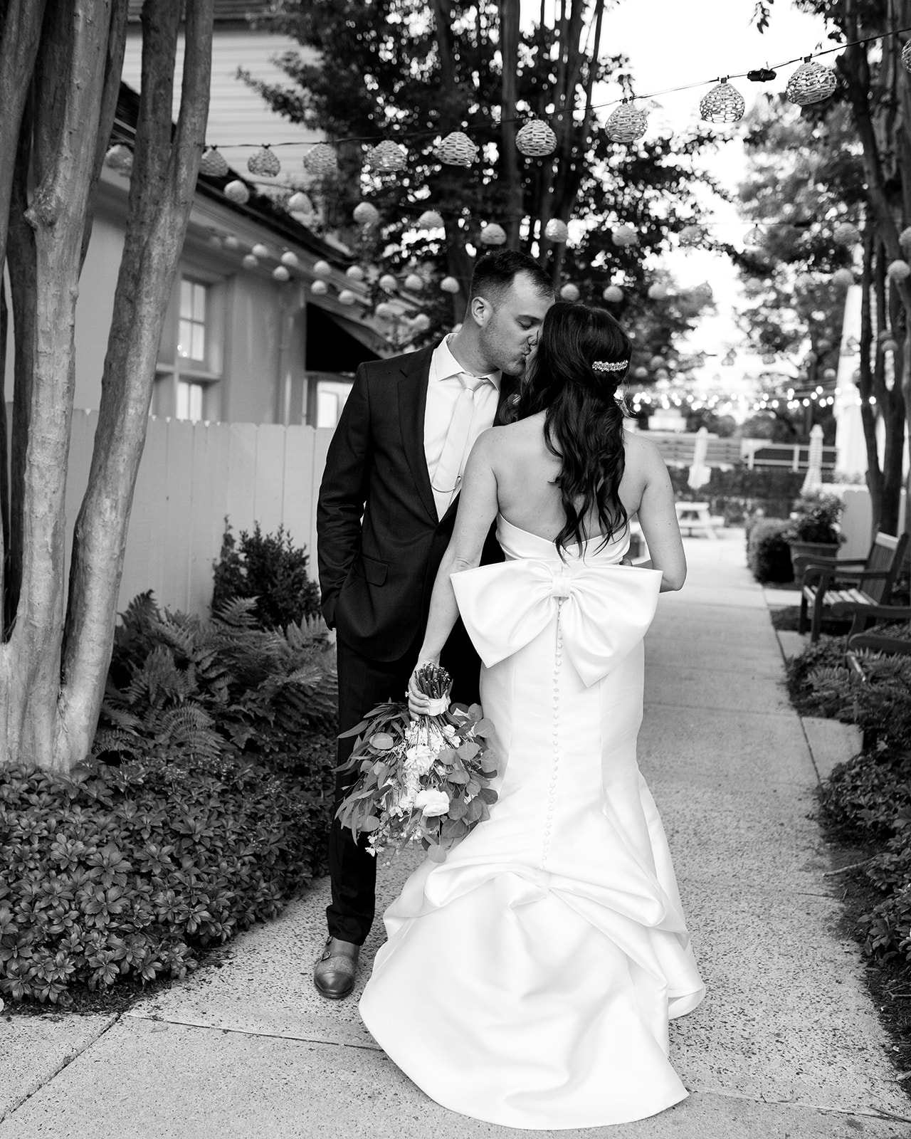 Black and white image of couple kissing at their wedding venue after saying their "I dos" | Megan Smith Photography