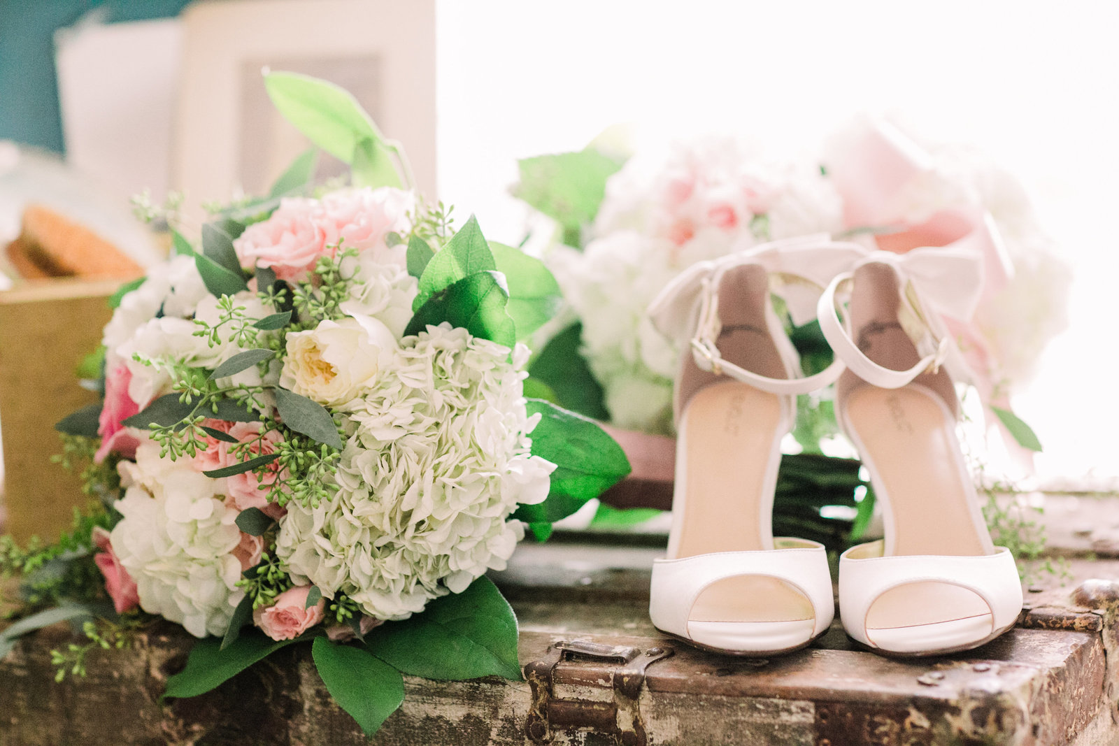 These details of Liz's wedding shoes and flowers pop in natural sunlight in the bridal cabin at Dodson Orchards