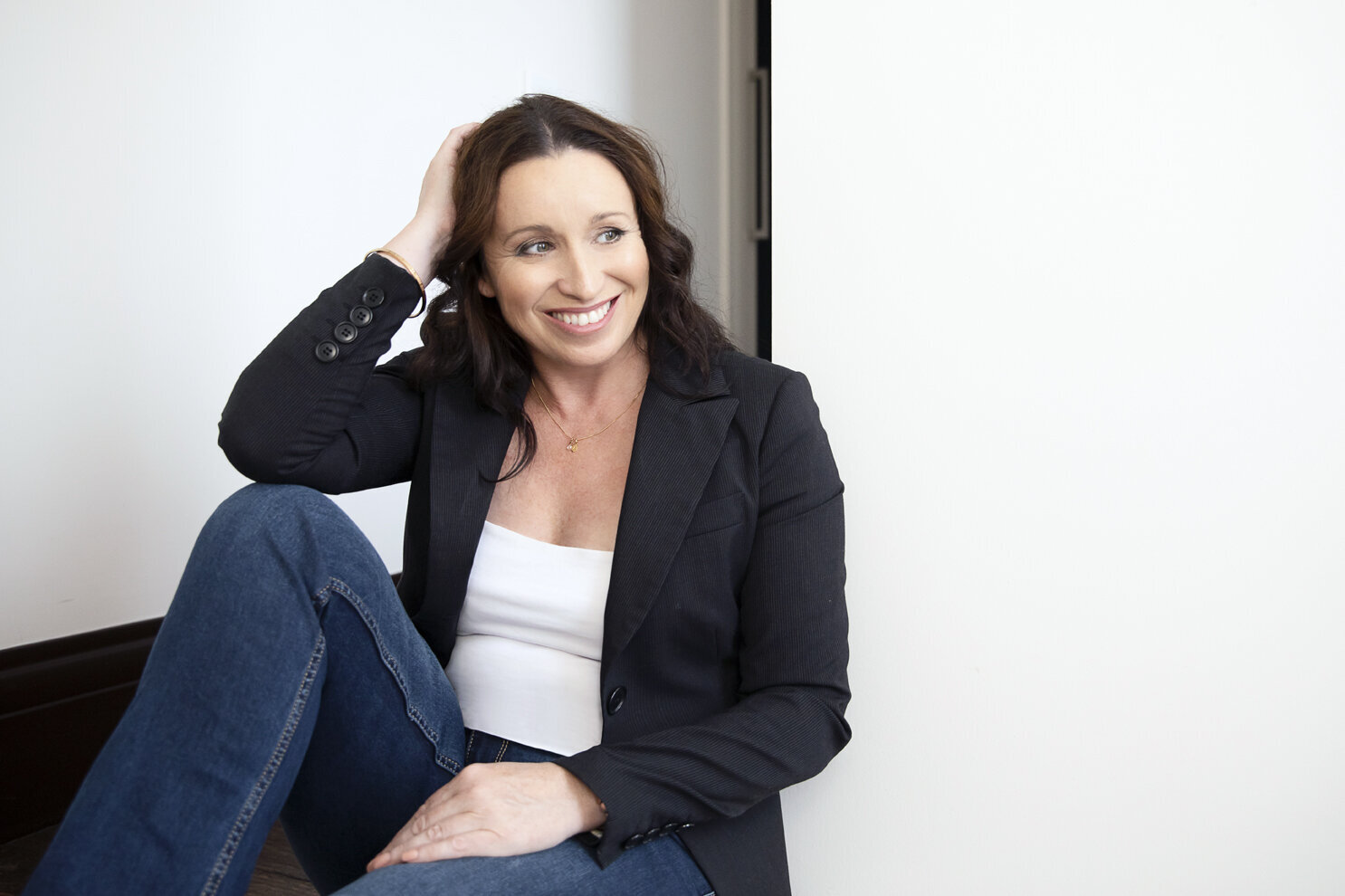 Lady sitting on floor and leaning against wall