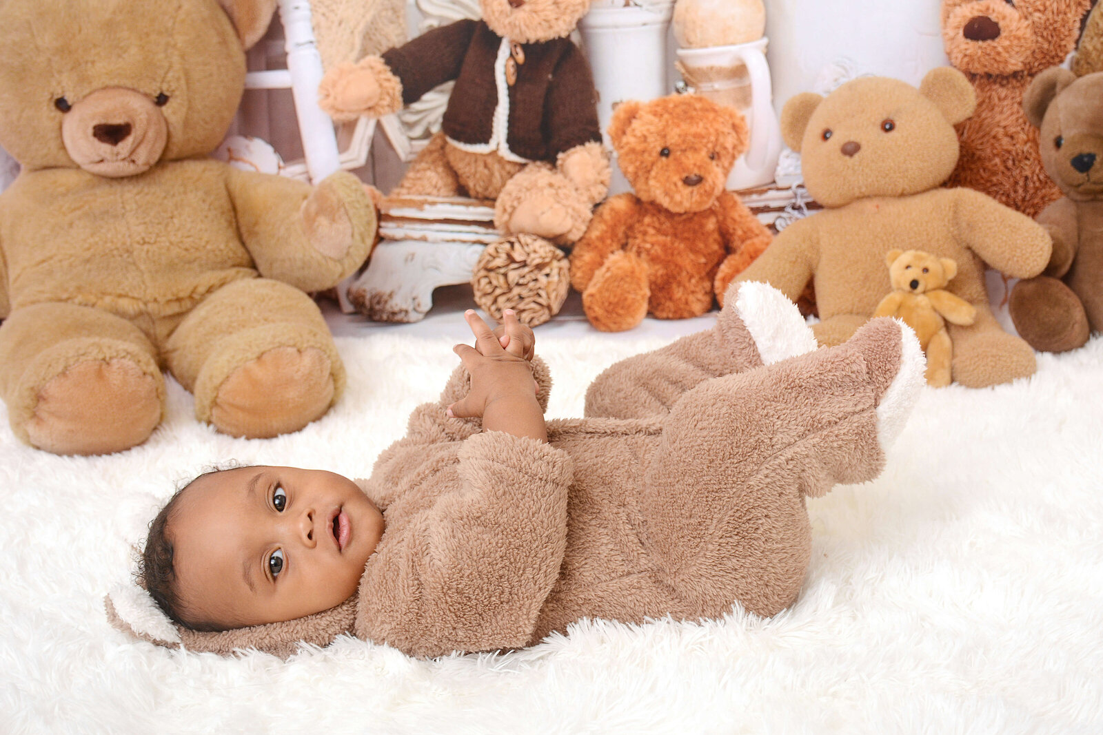 boy smiles at his teddy bear photoshoot