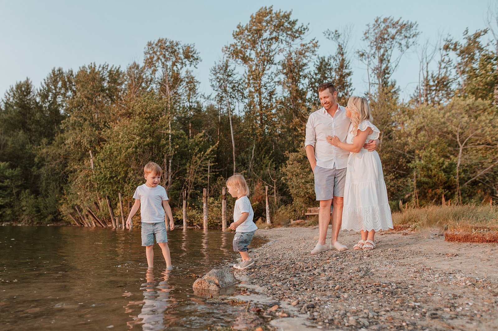 Family of four on beach playing with Vancouver Family Photographer