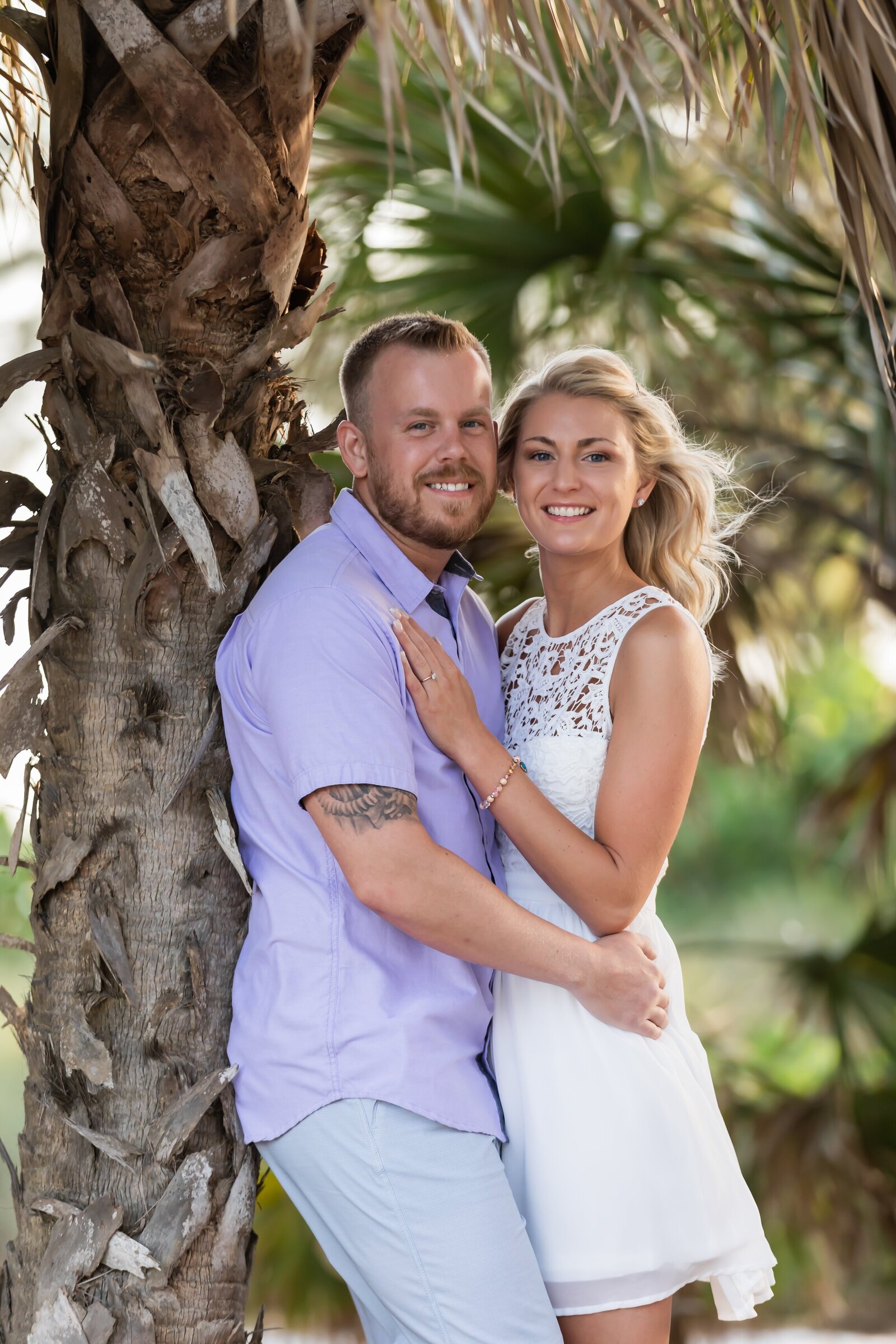 beautiful couple with palm tree on Anna Maria Island