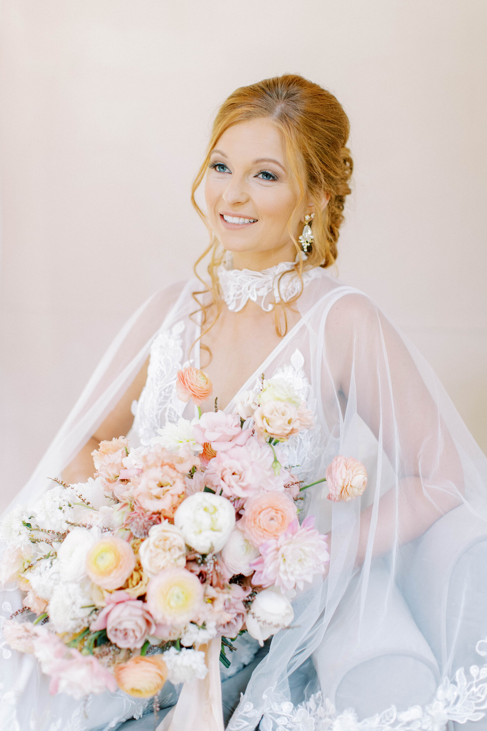 Bride lounges with peachy bouquet for bridal portrait editorial