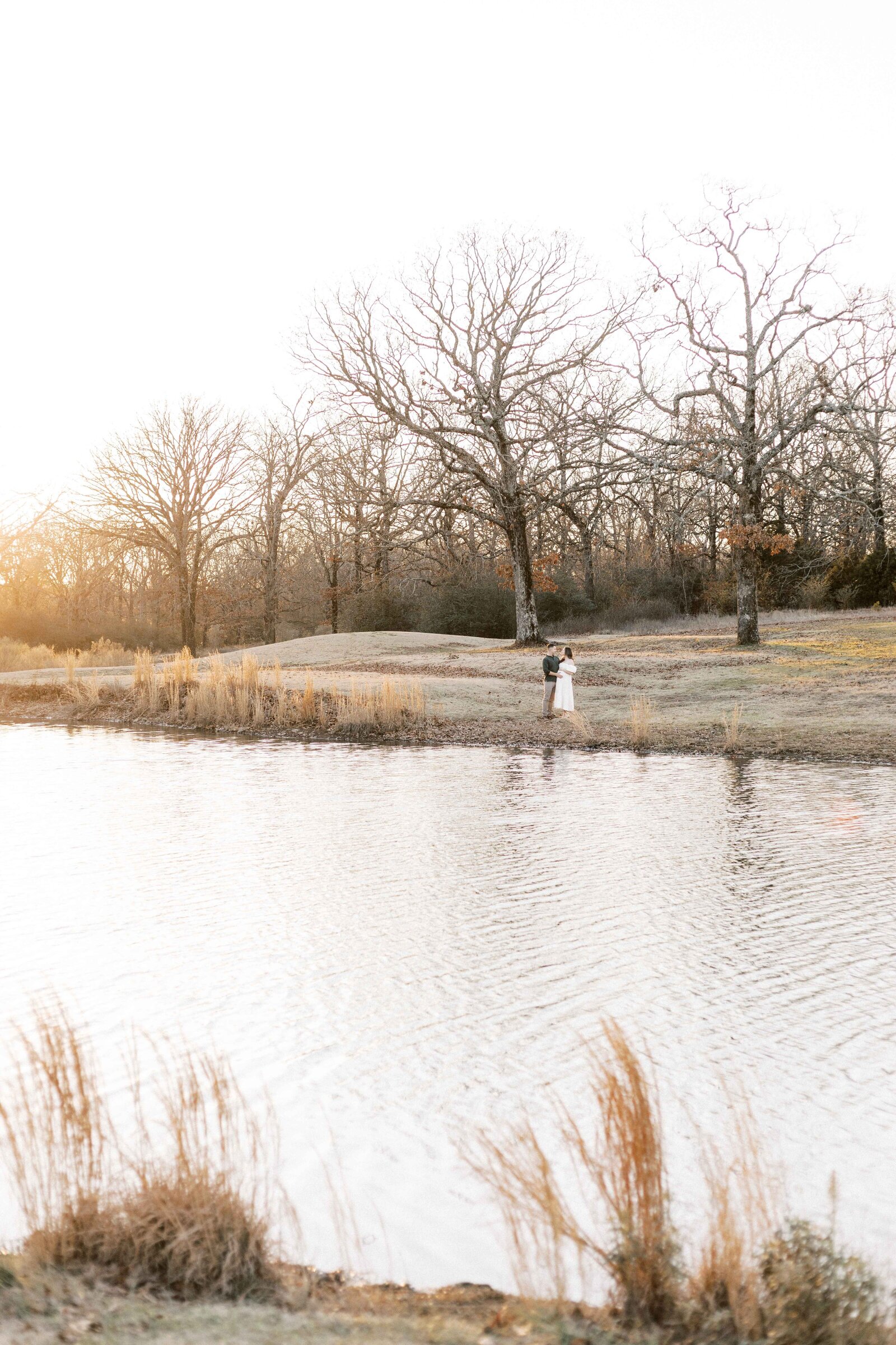 couple standing at lake during sunset in peoria illinois family photos 