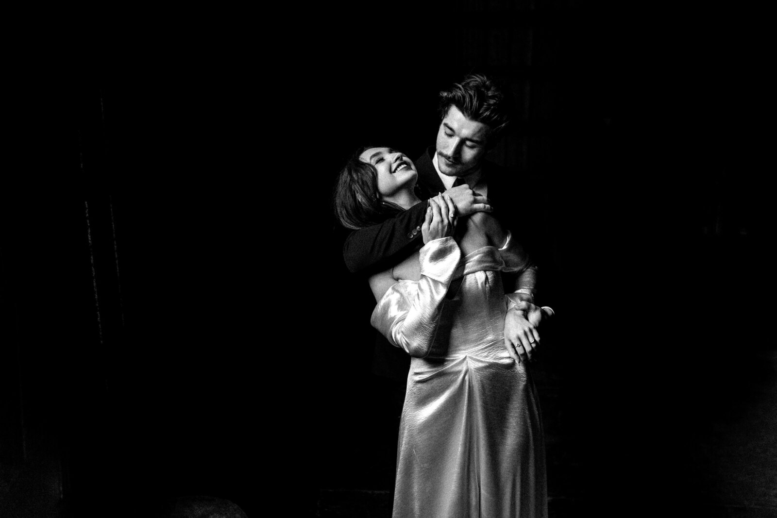 Image of couple in front of a moving train in the subway train station