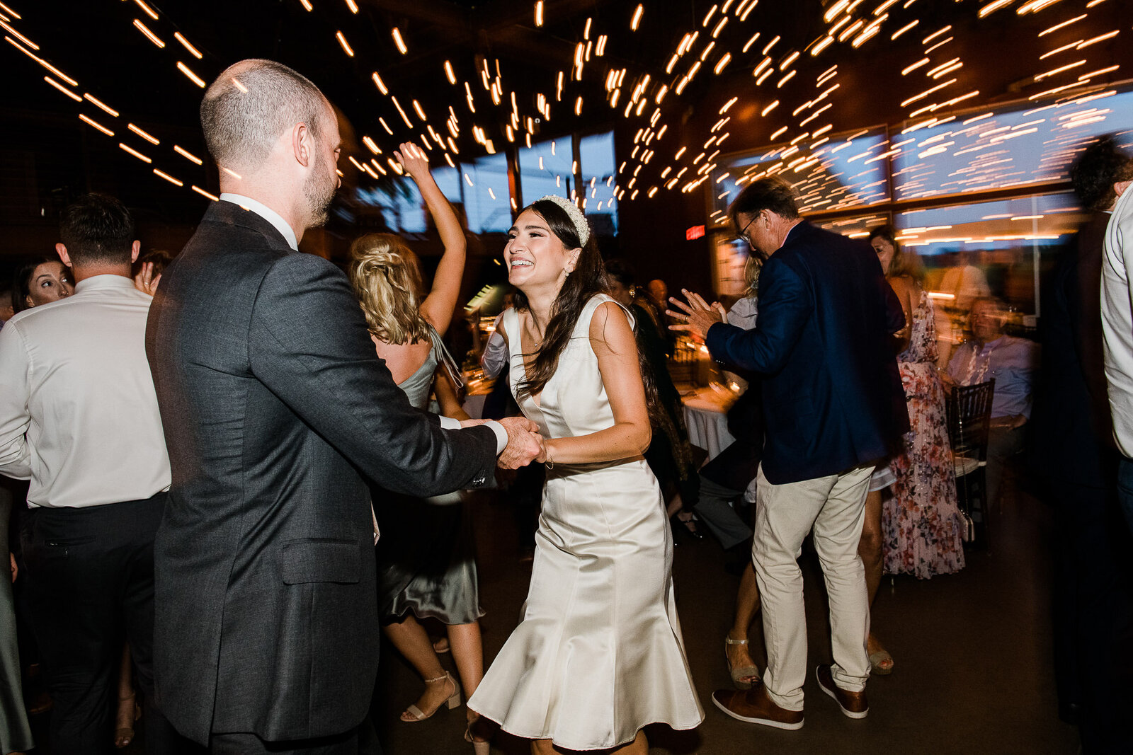bride and groom dance with light streams