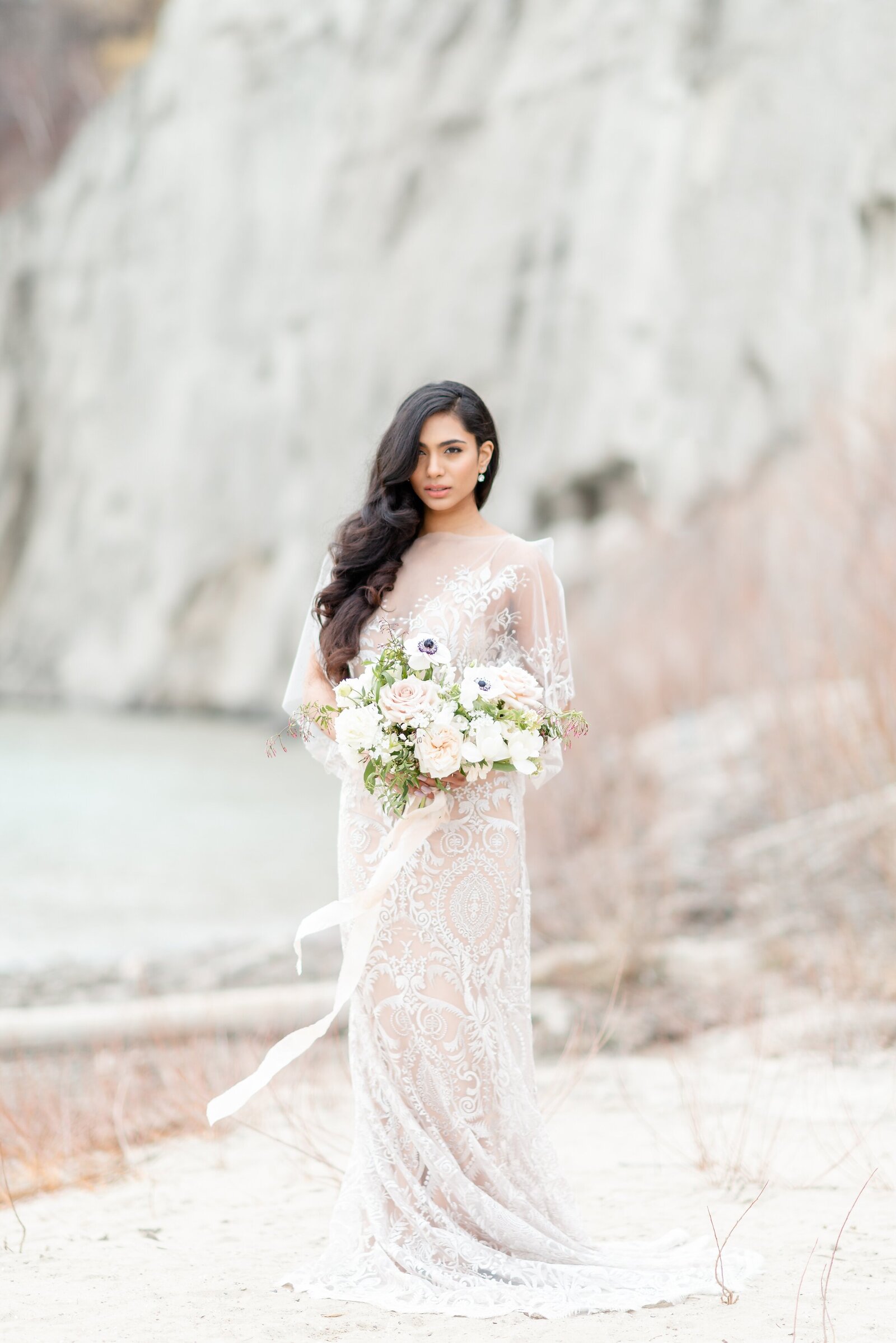 Bride-with-beautiful-long-hair-in-a-lace-wedding-dress-on-the-beach-in-southwestern-ontario