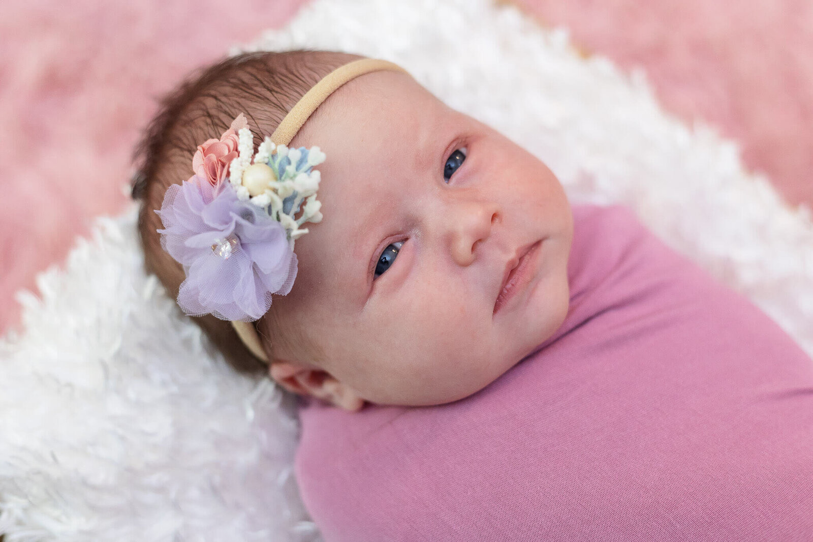 A close-up of a newborn girl's face.