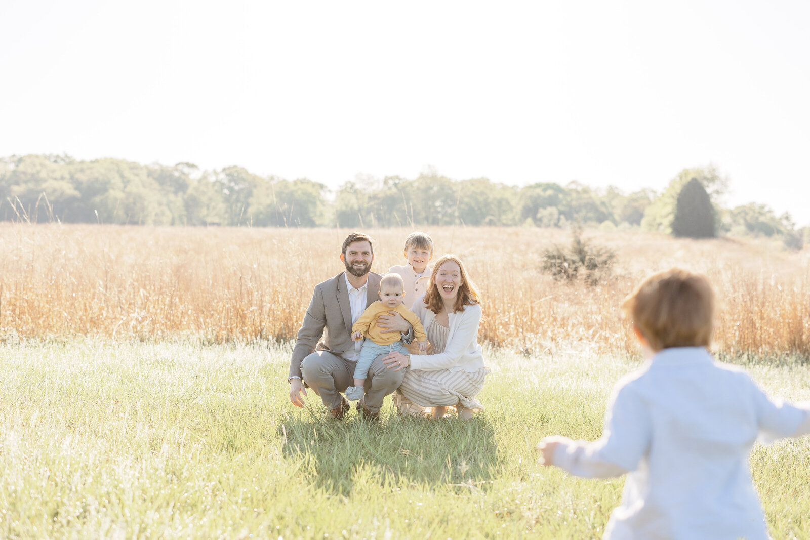 boy running towards family during Fauquier County, VA session