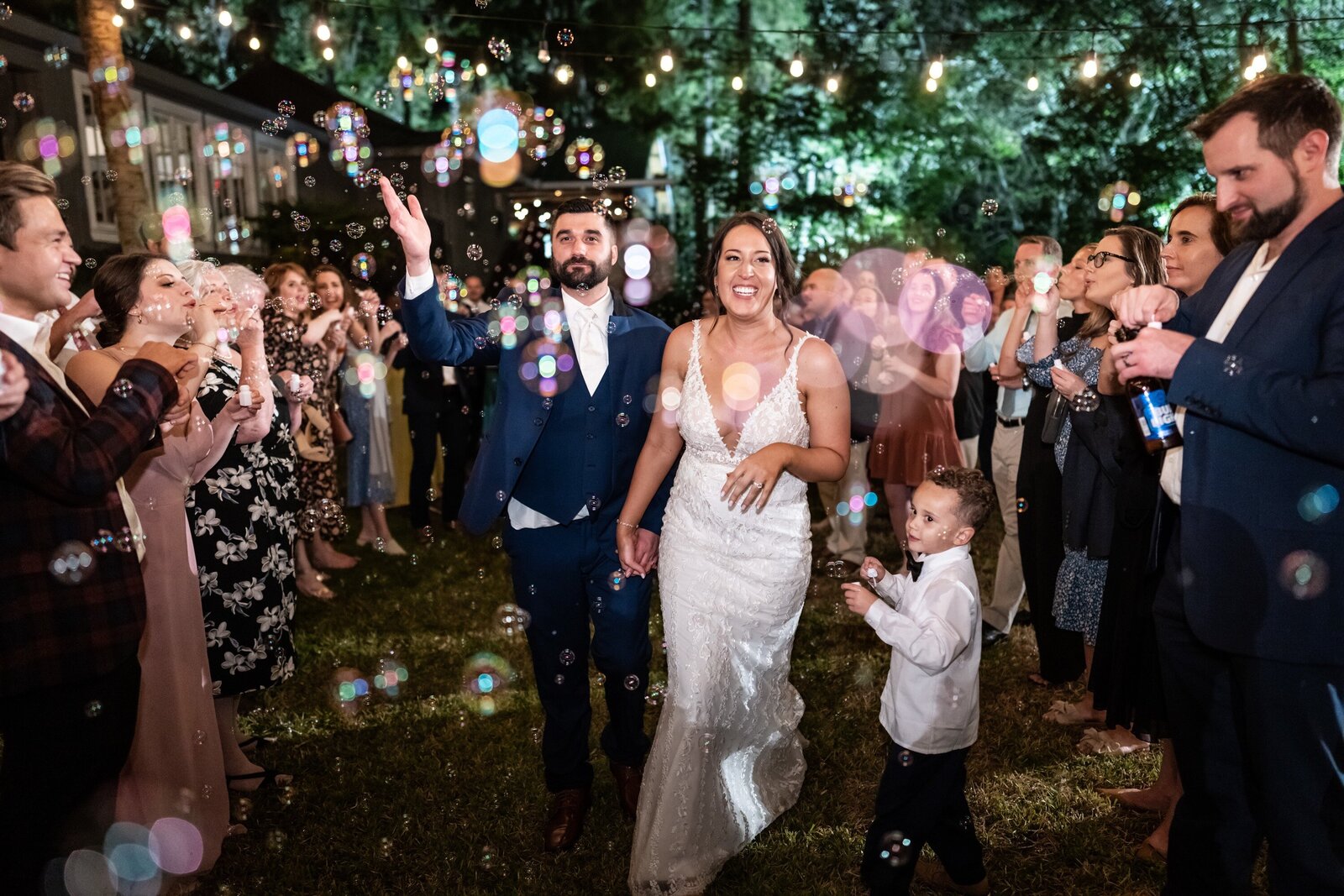 Bride and groom depart through bubbles at Palmettos wedding in Slidell Louisiana
