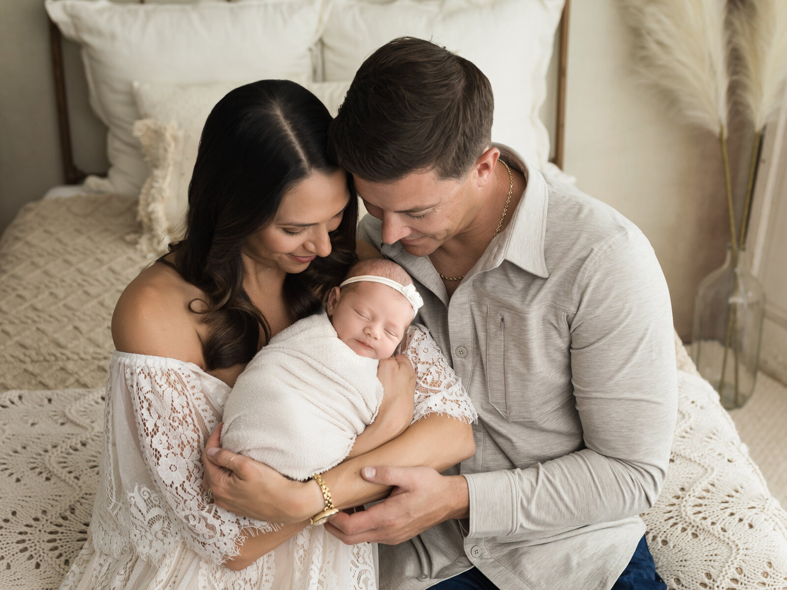parents holding newborn baby girl for studio portraits