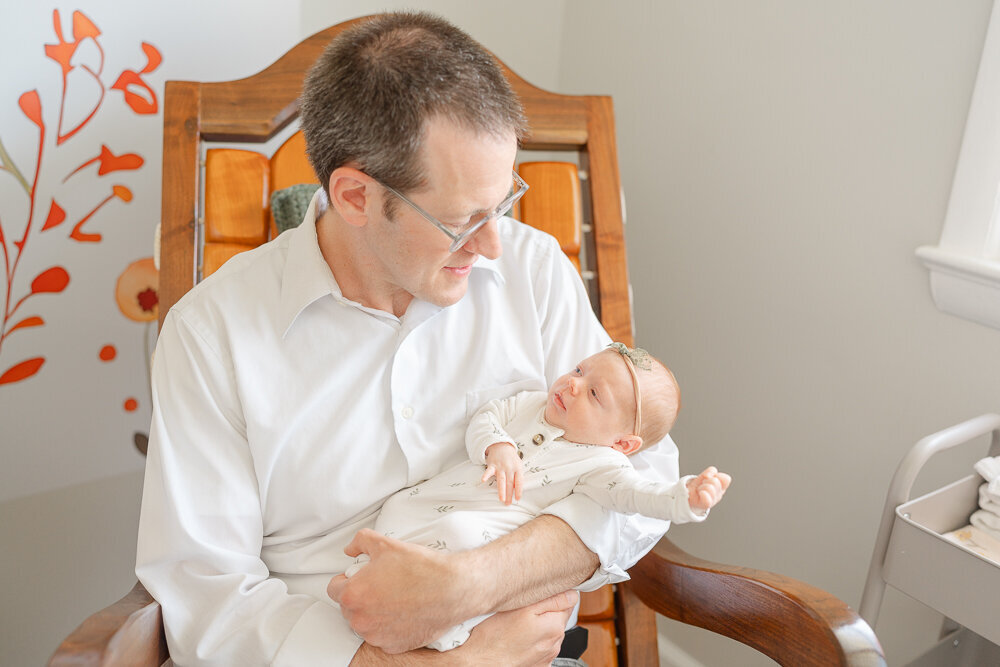 dad and baby on the rocking chair during McLean, Virginia newborn photography