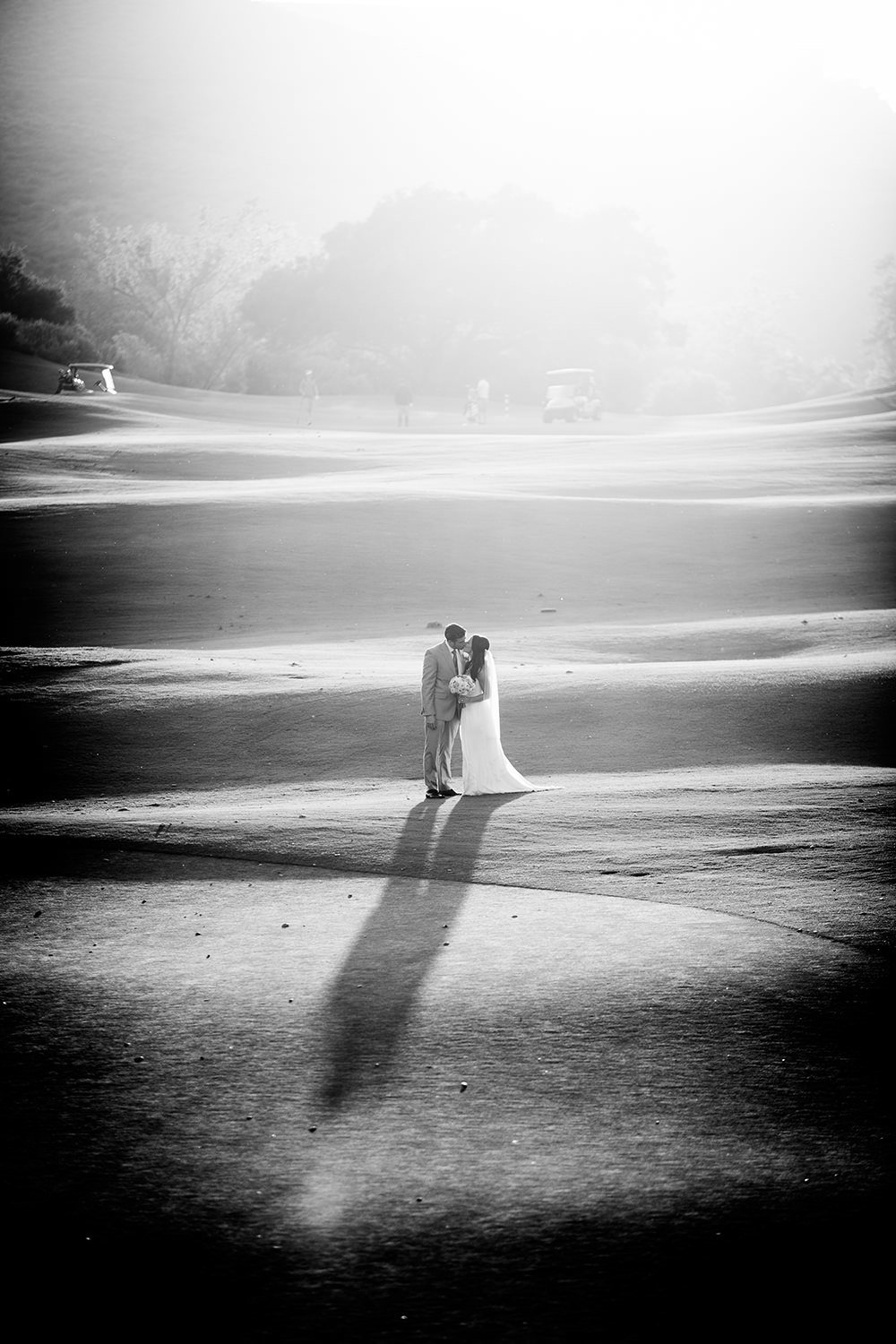 bride and groom in open field black and white