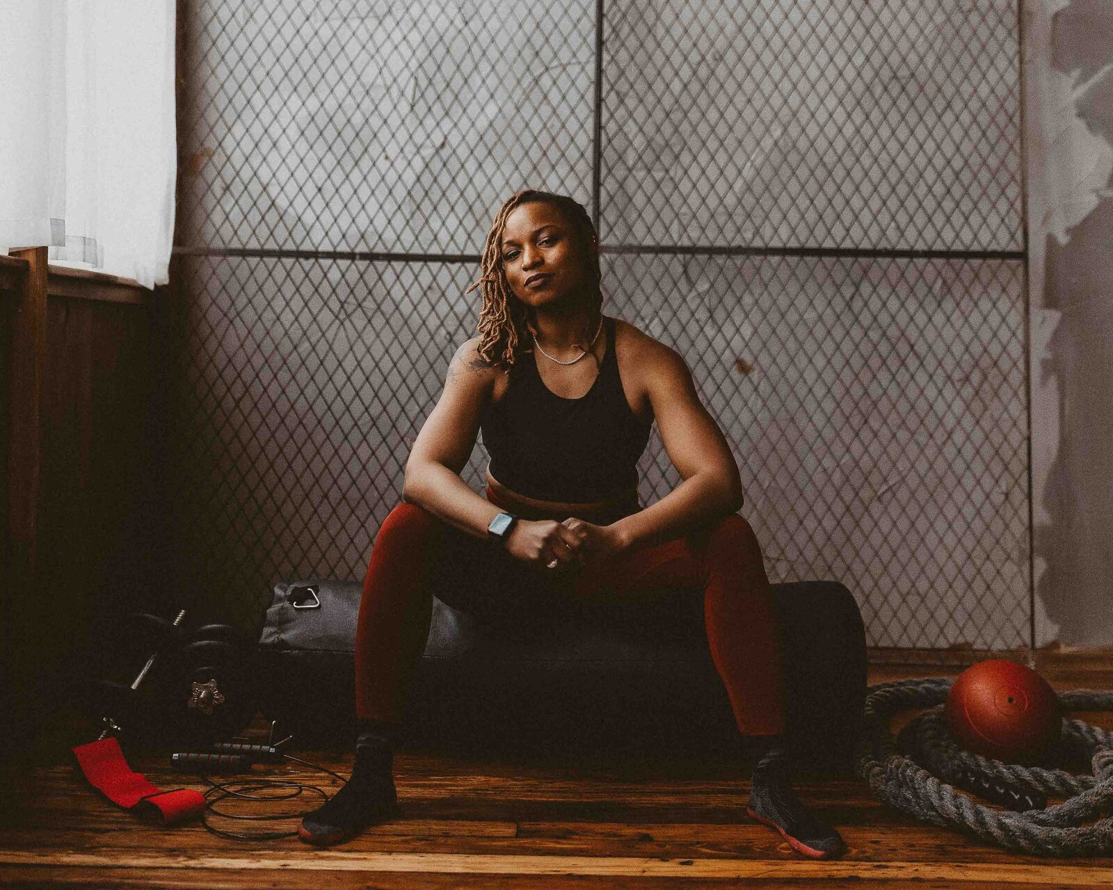fit woman sitting on a punching bag