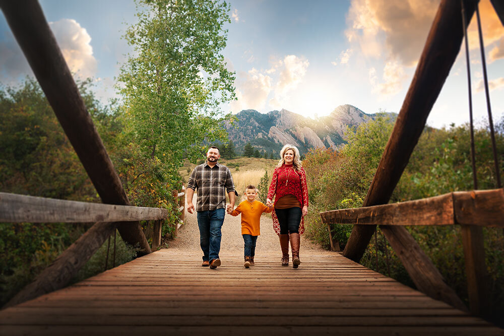 bridge-wooden-south-mesa-trailhead-family-walking-holding-hands-little-boy-sunset-mountains-flatirons
