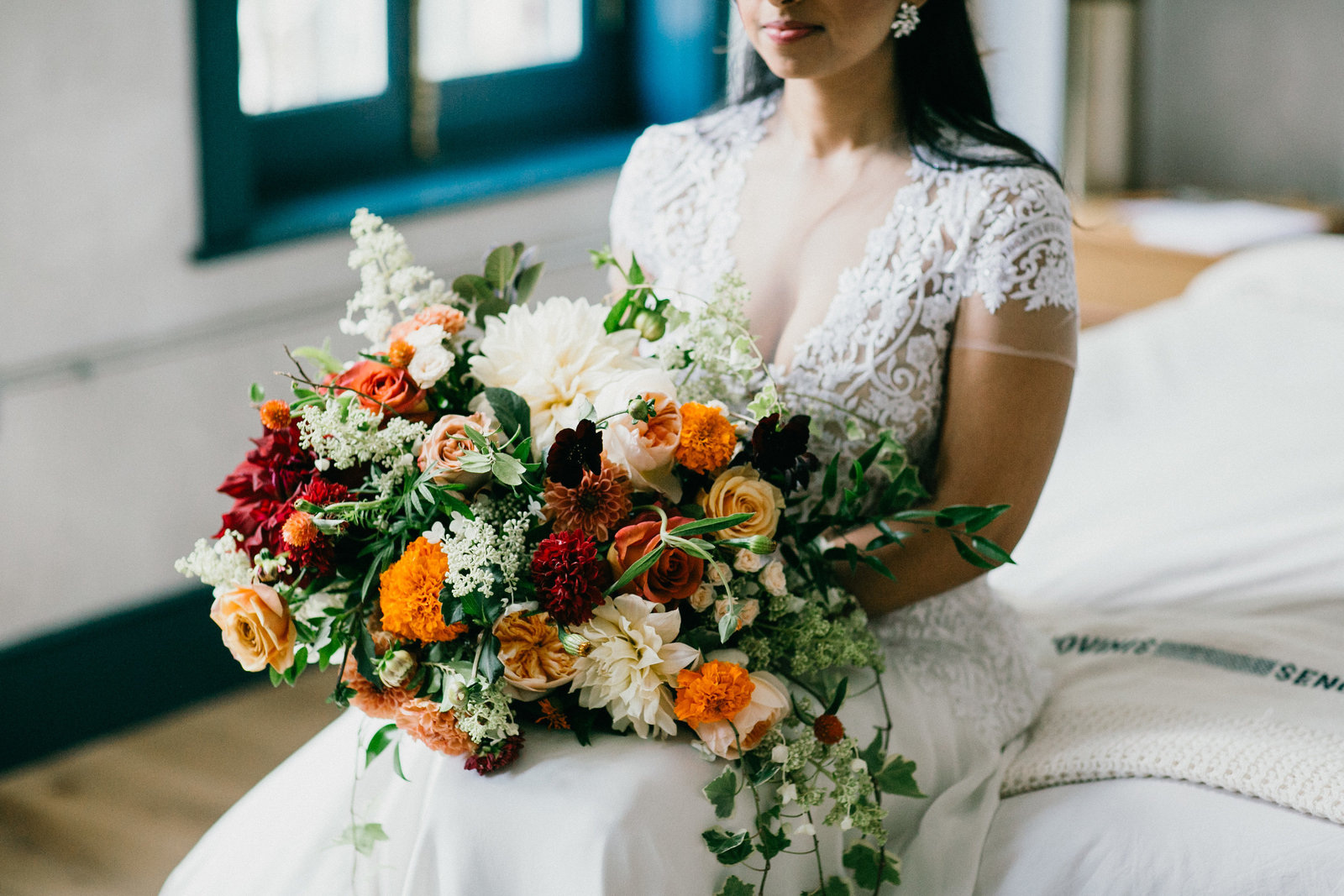 Gorgeous big floral bouquet with pops of orange and red, at Lokal Hotel.