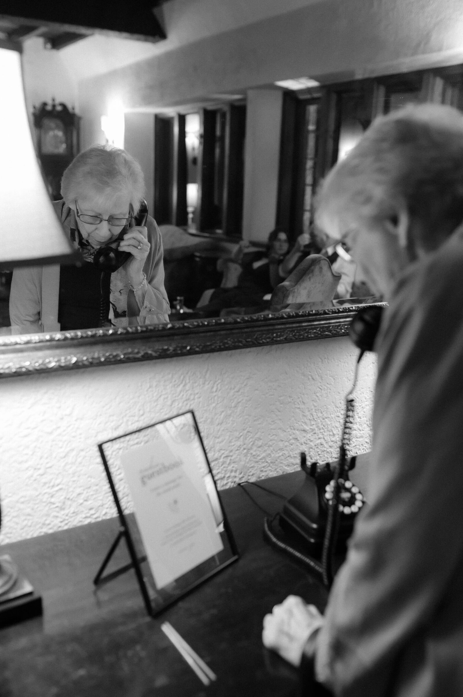 black and white photo of grandma leaving the couple a guest book voicemail