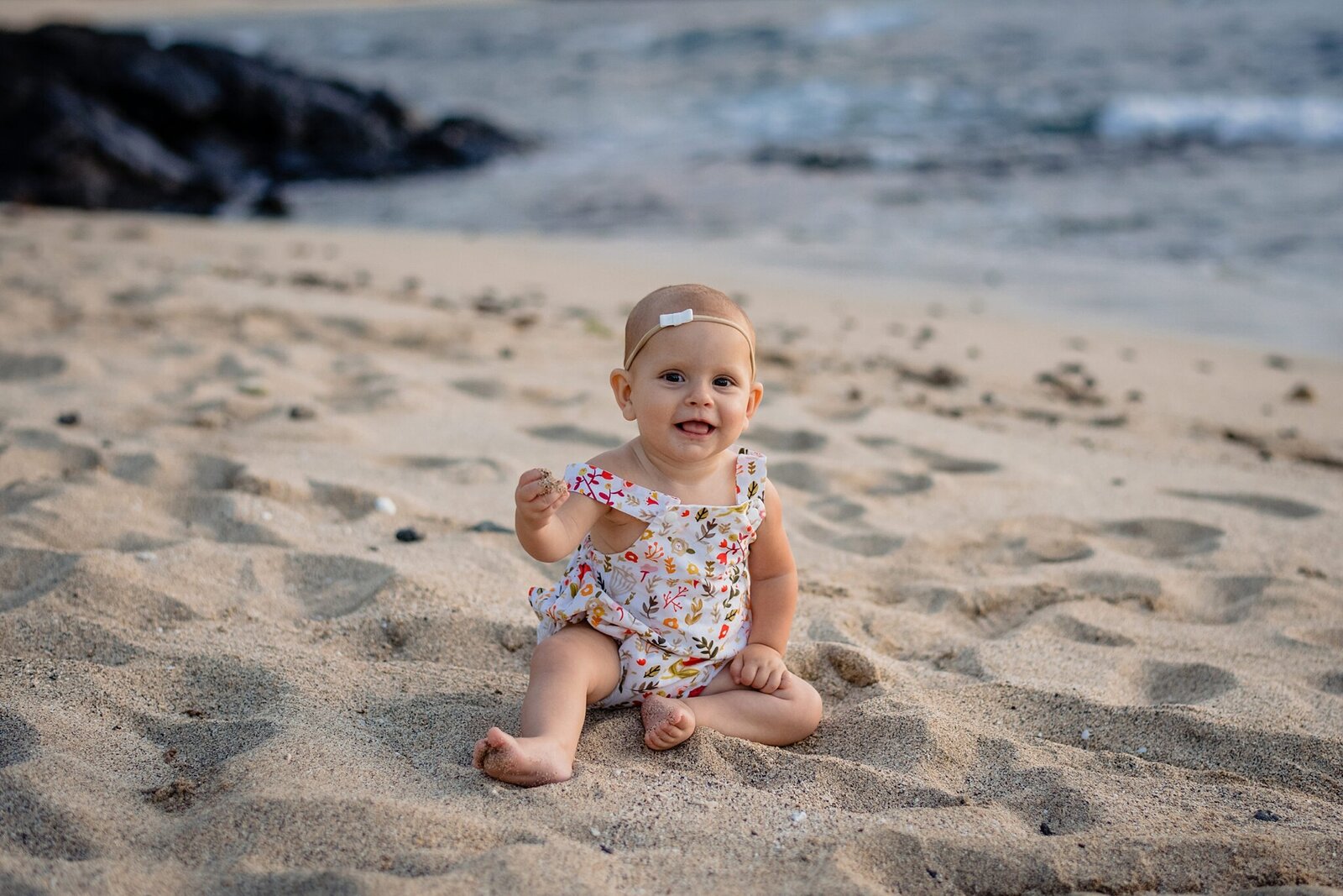 baby sitting on the sand