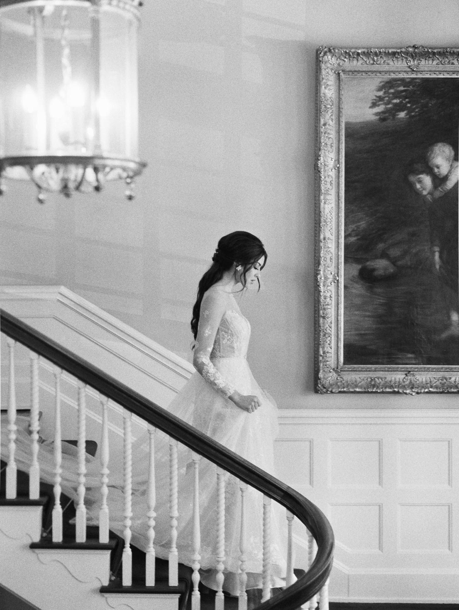 Bride coming down stairs in a castle