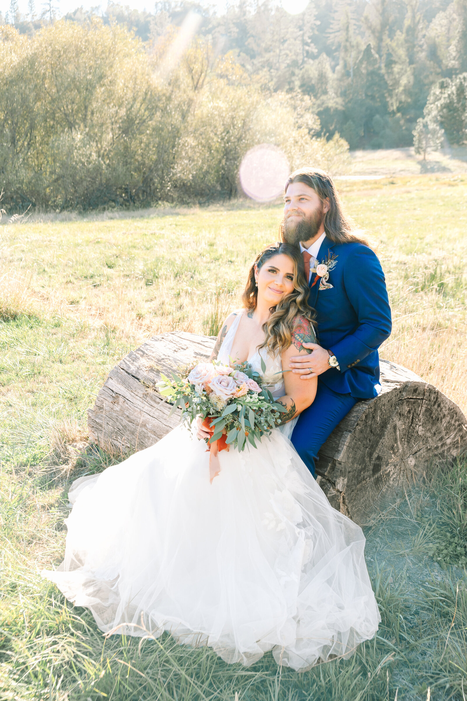 Tattoo bride and groom embrace on their colorful wedding day in Santa Cruz, California.
