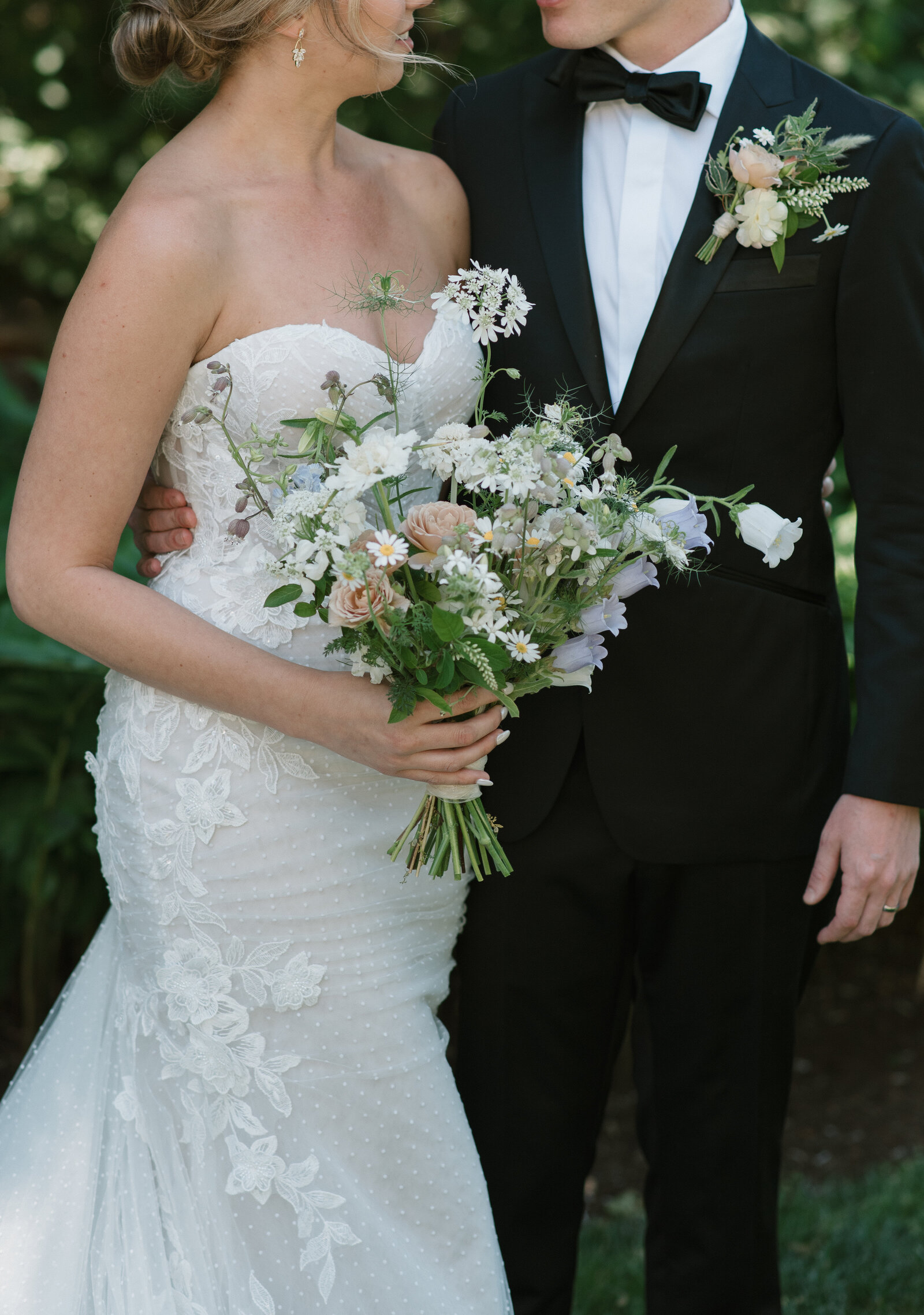 close up photo of a bride and groom and their outfits