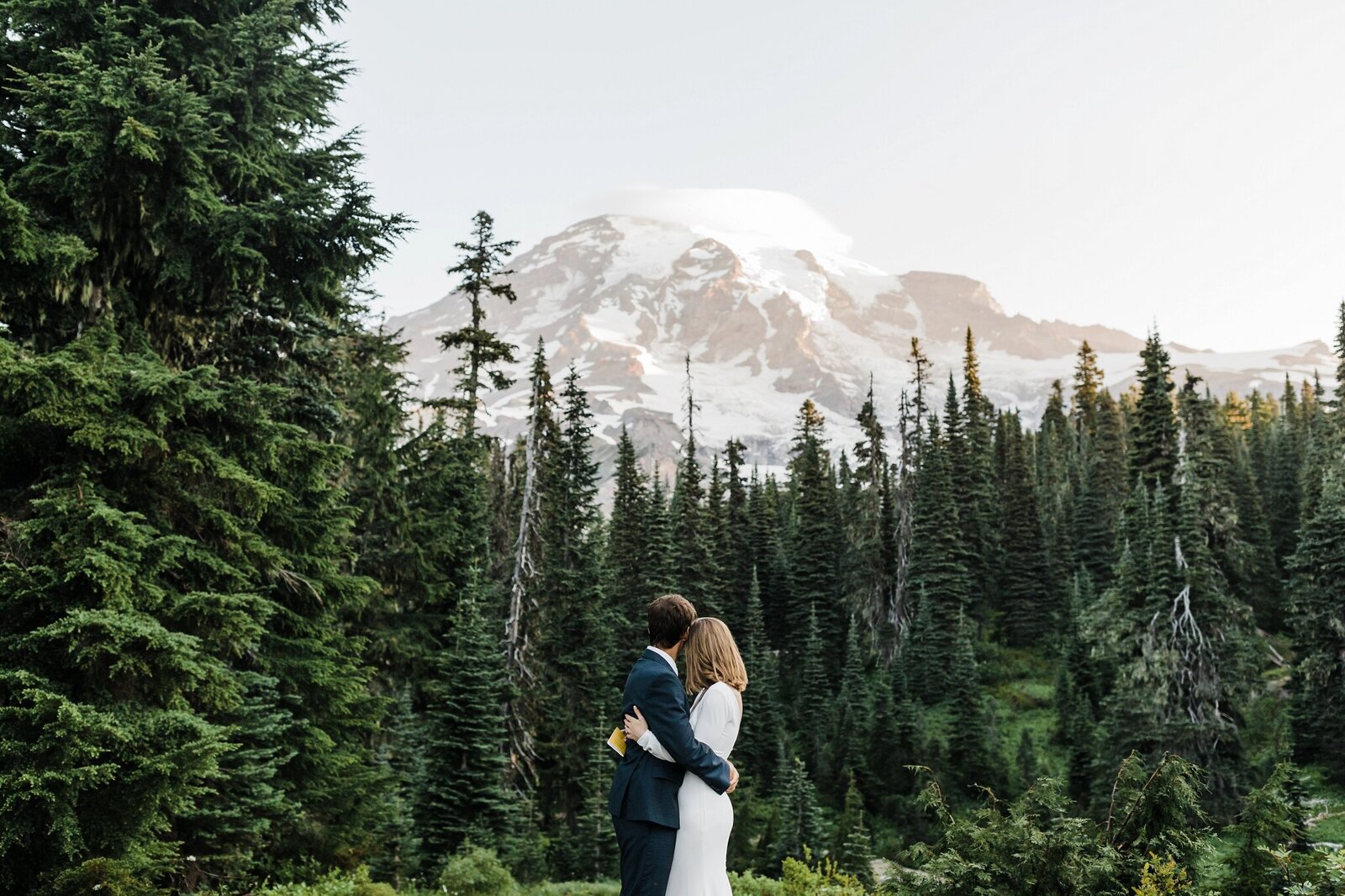 A bride and groom embrace after reading their vows during their sunrise elopement at Mt. Rainier National Park in Washington. | Erica Swantek Photography