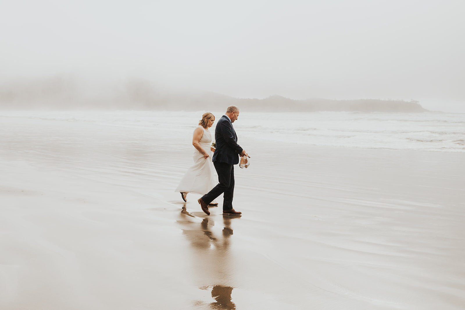 A bride taking a moment by the sea in Victoria Bc
