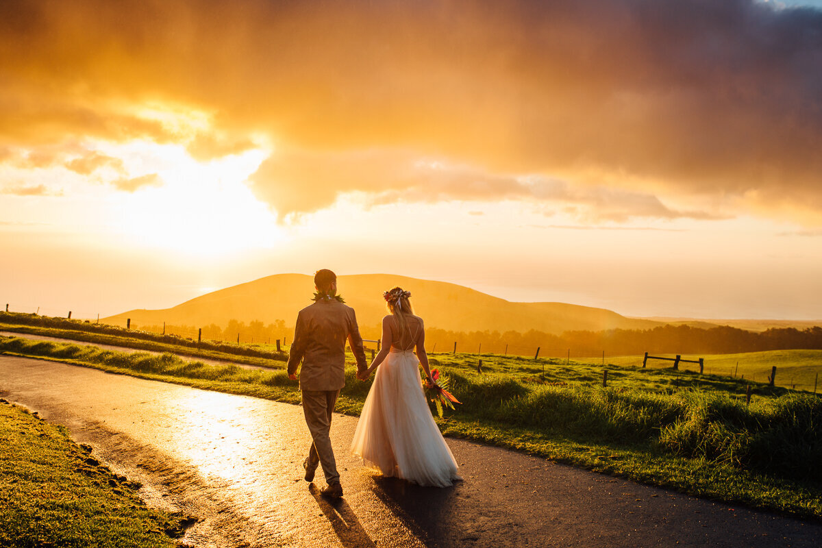 couple walking in the sunset after their big island wedding