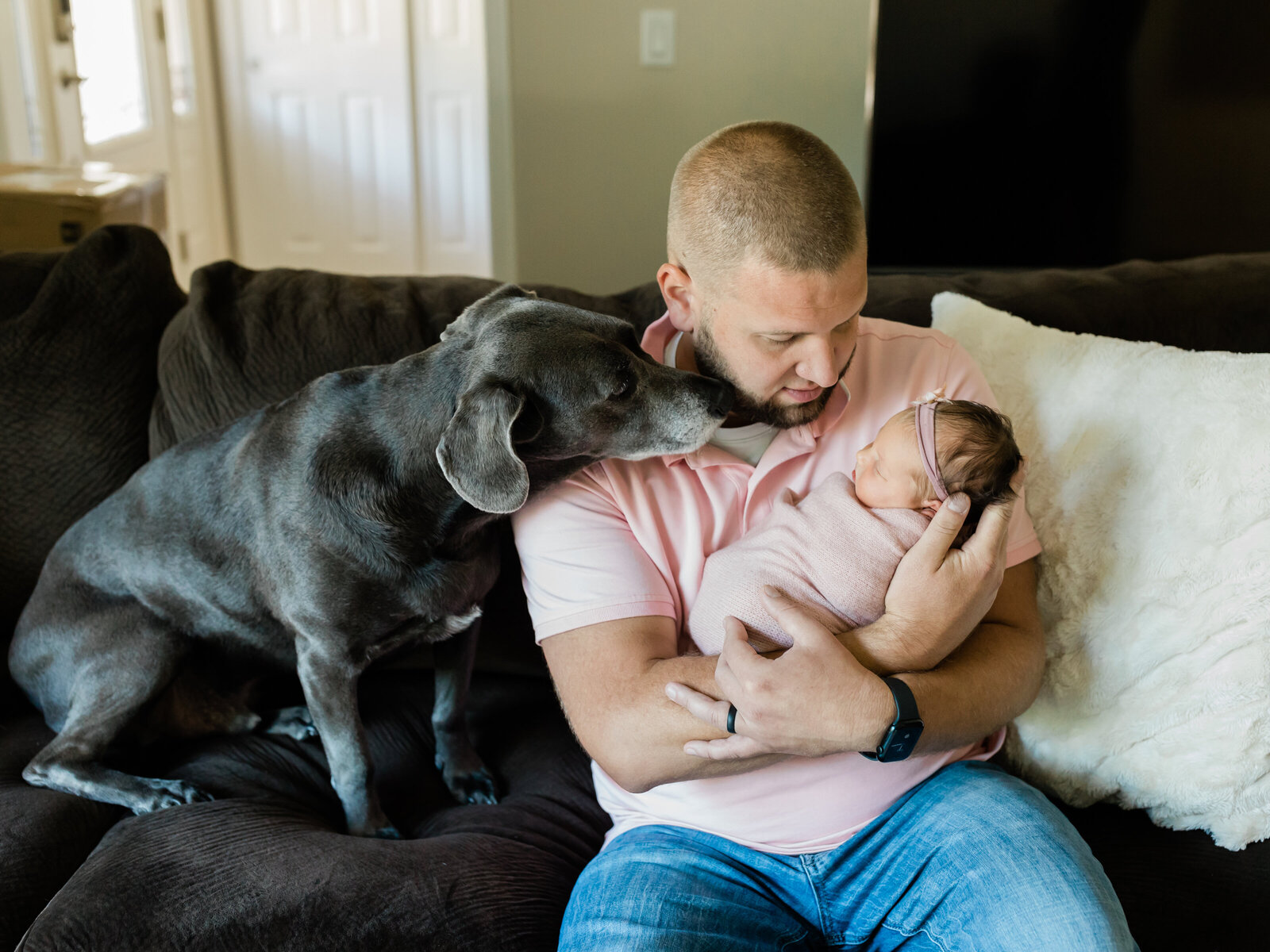 Newborn baby with dad and dog
