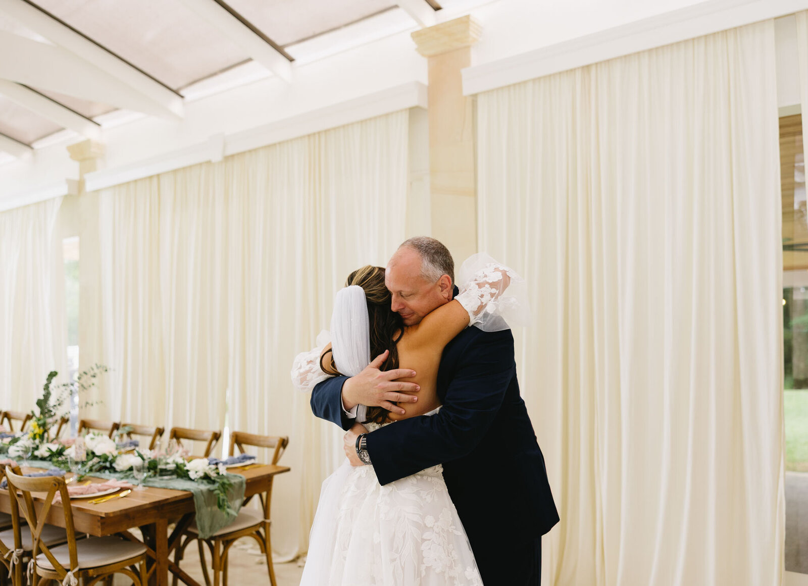 Bride hugging her father during their dance