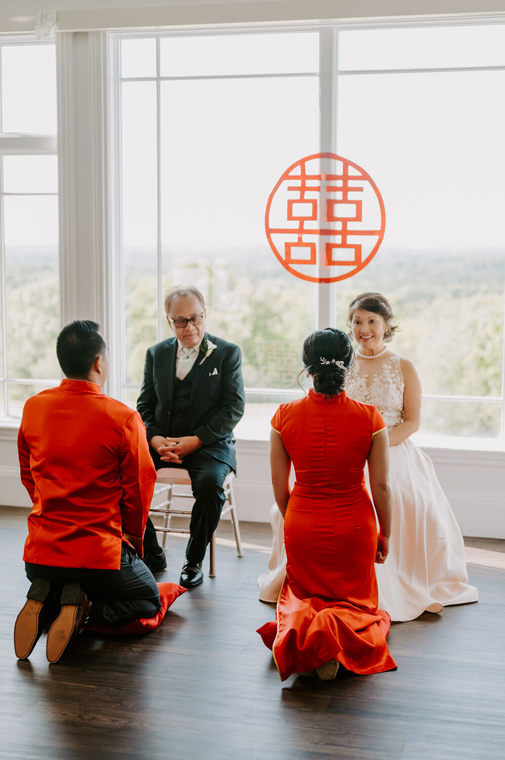 Traditional wedding tea ceremony with the couple kneeling before elders