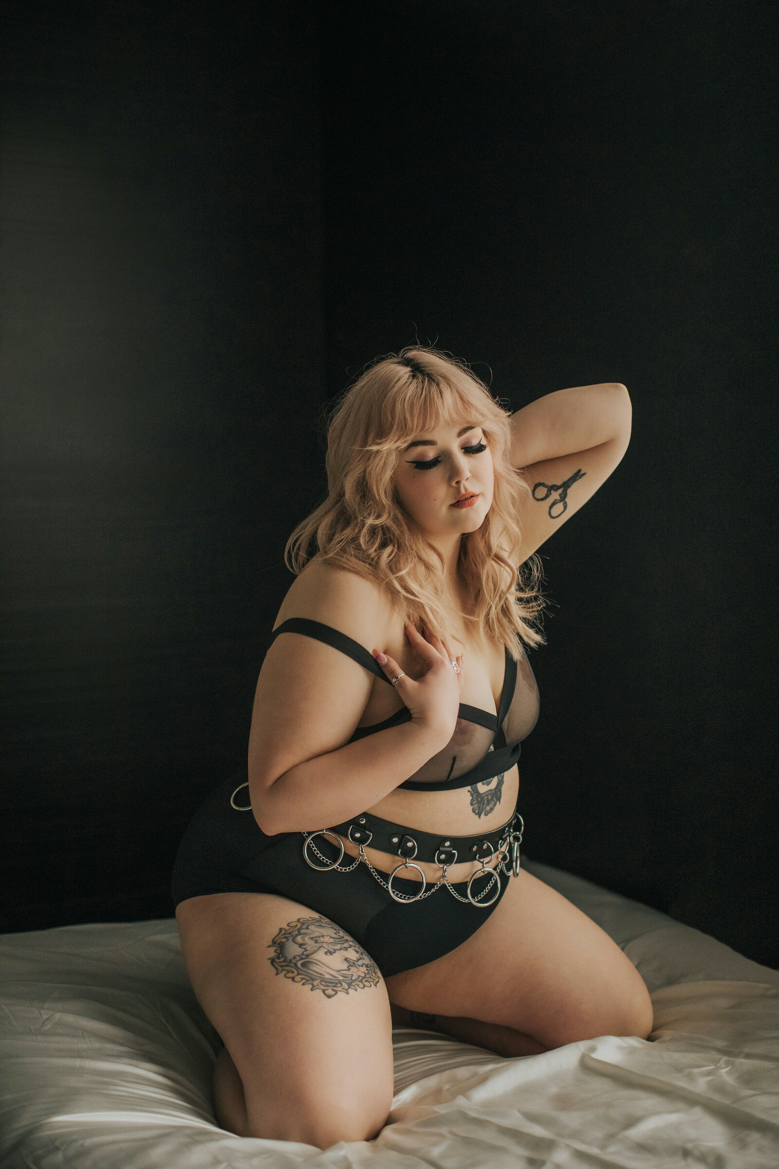 beautiful tattooed model posing on bed