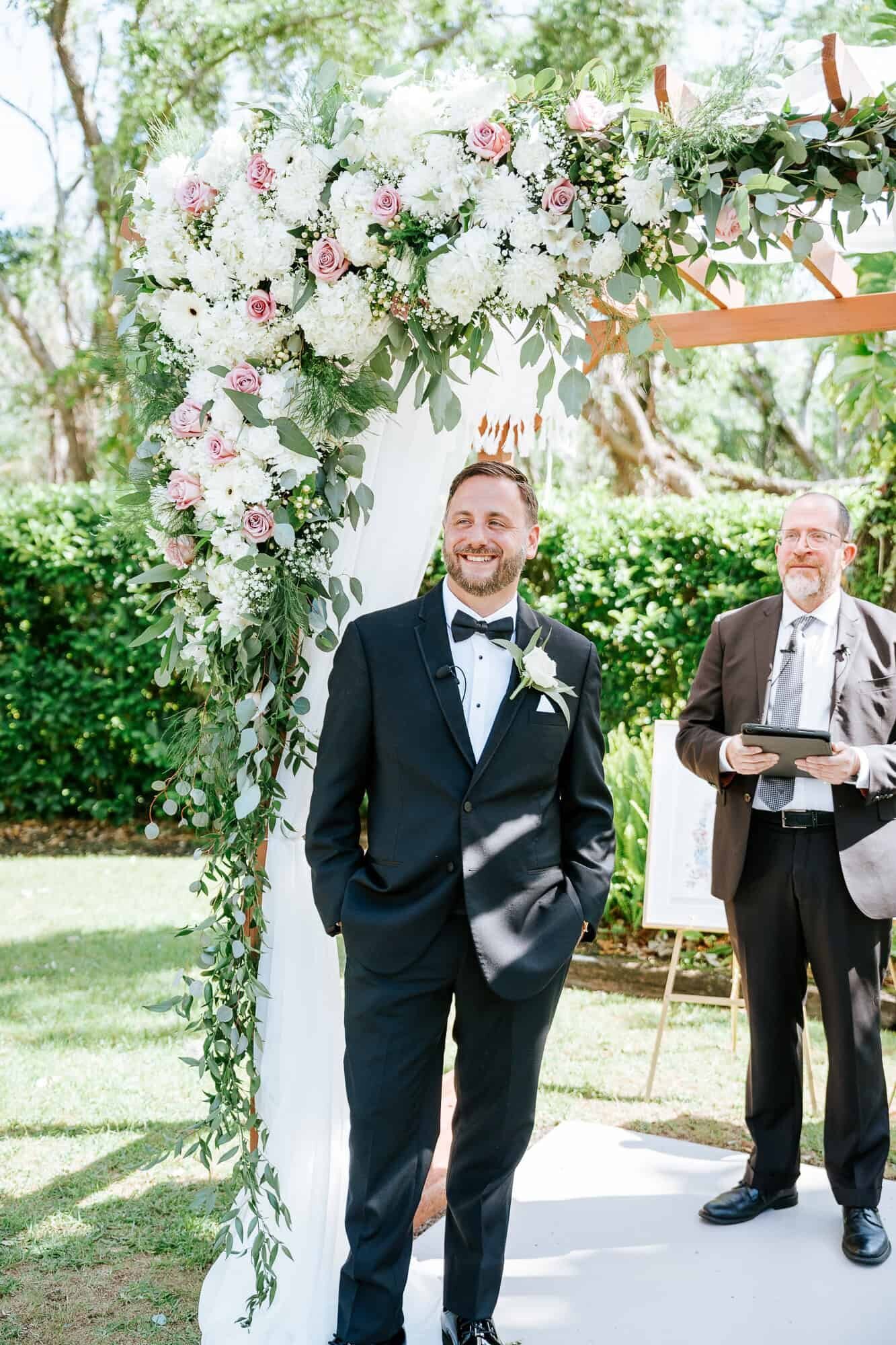 Groom awaiting his bride to walk down the aisle at Bakers Ranch Wedding