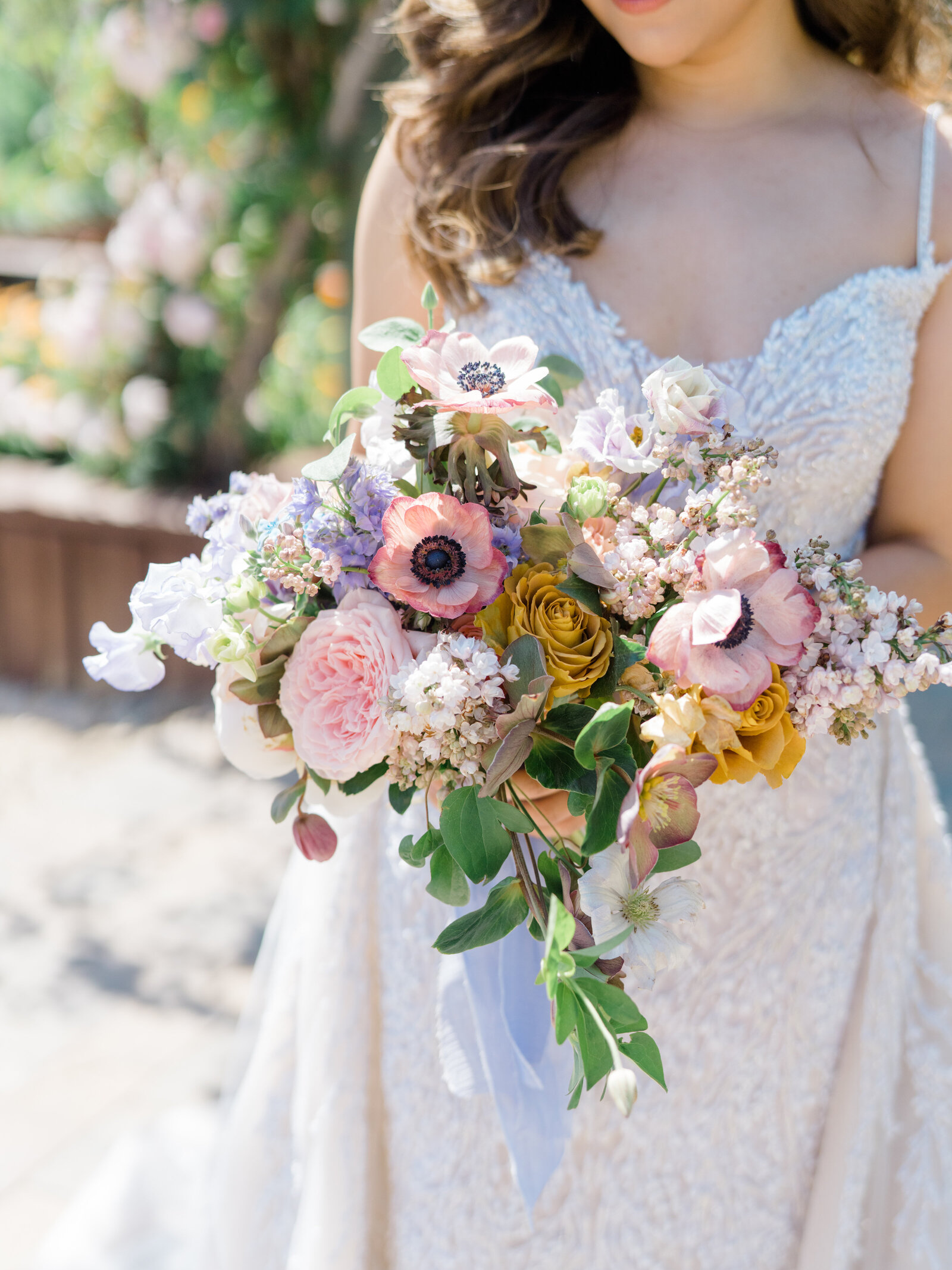 bridal bouquet with pink poppies and yellow, purple, and blue  flowers