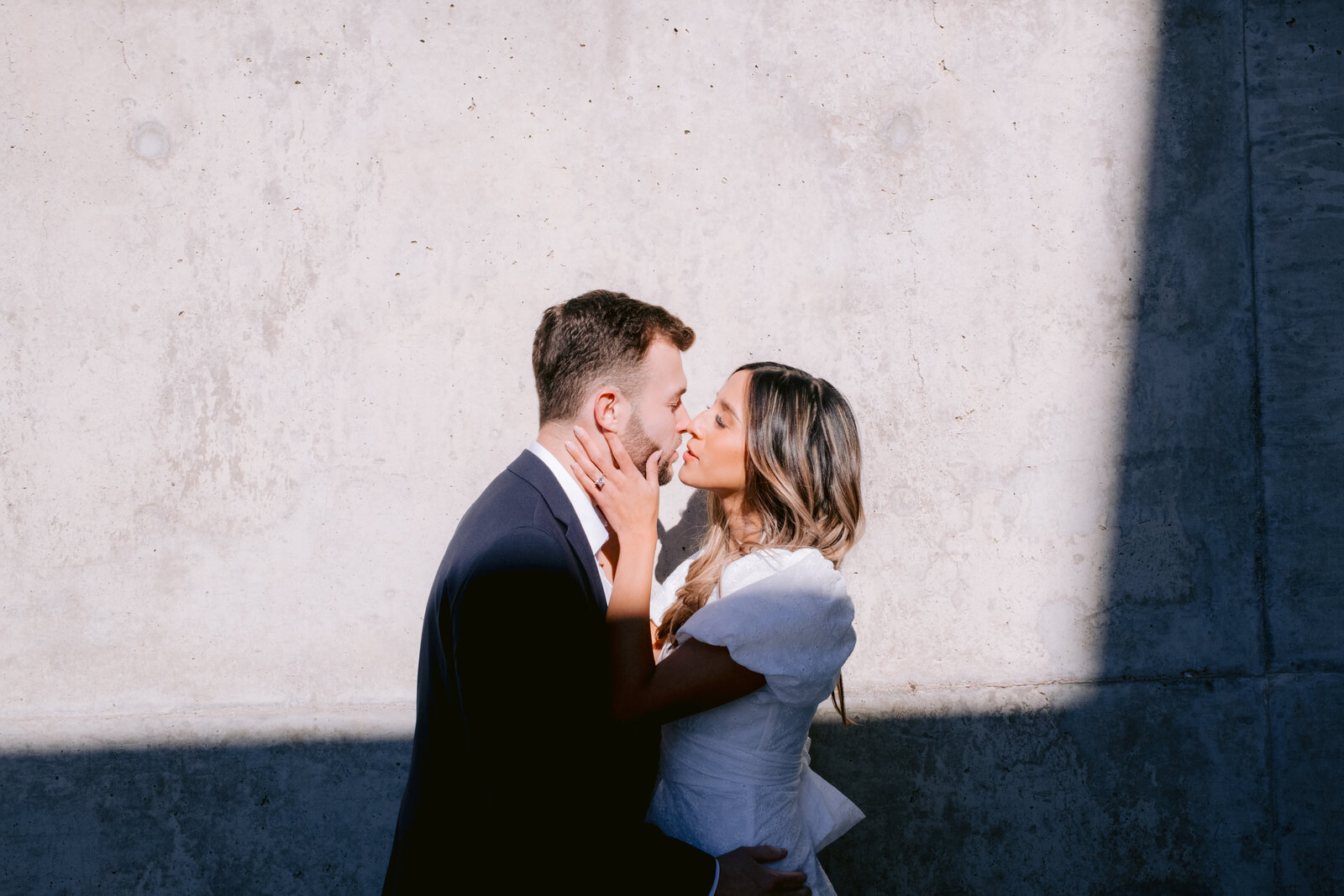 Engagement photo of a dressed up couple looking in each other's eyes in downtown Phoenix Arizona
