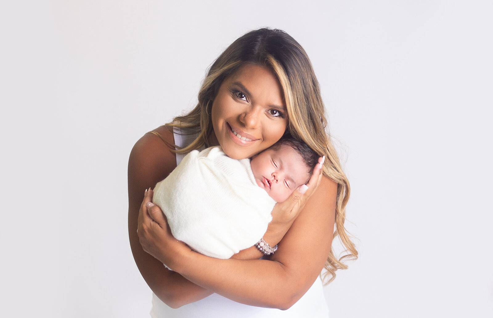 Mom holding newborn baby close to face during newborn photoshoot with Nashville, Tennessee newborn photographer