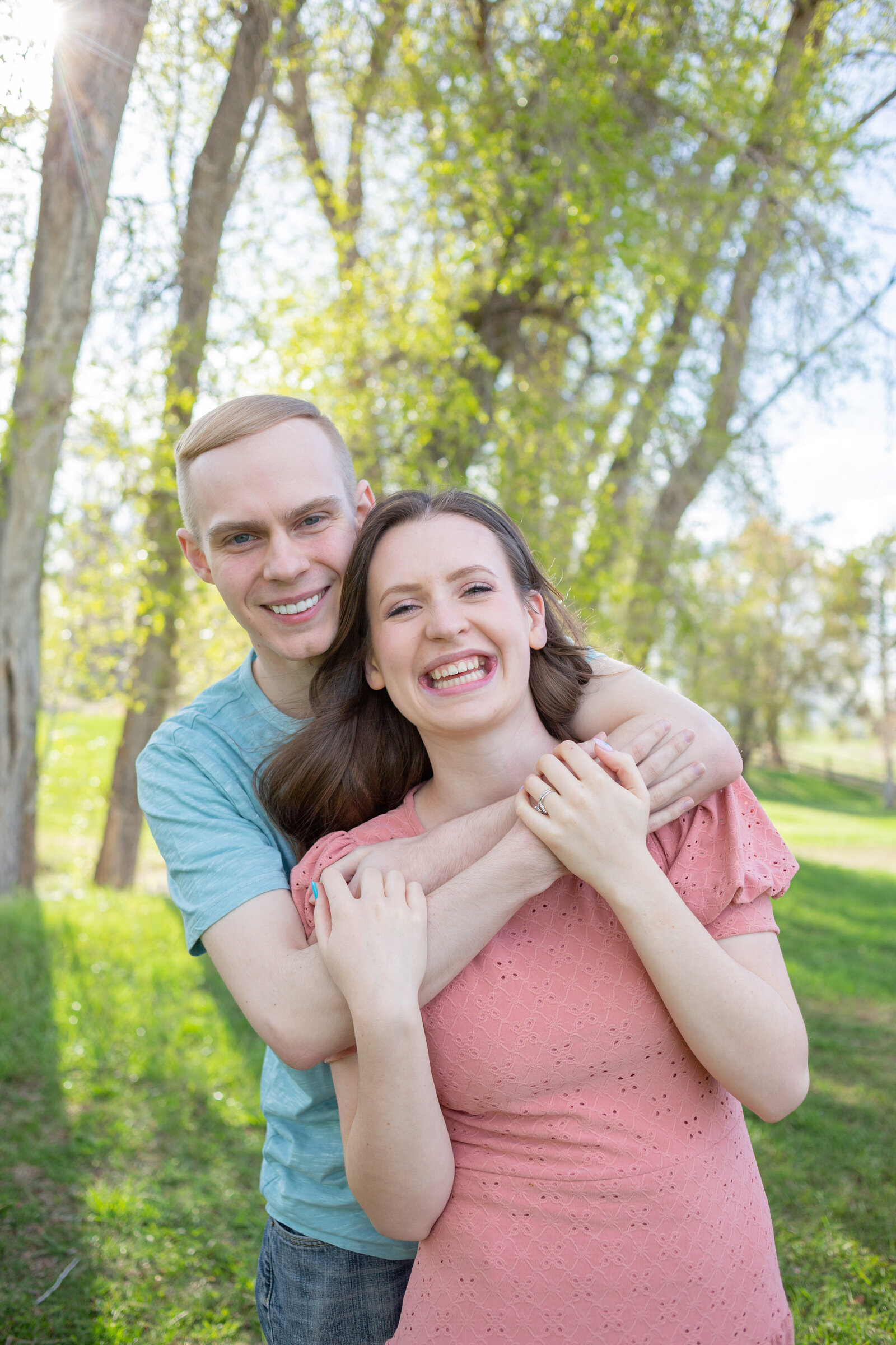Seattle Wedding Photographer captures couple wrapped in each others arms smiling and looking at the camera