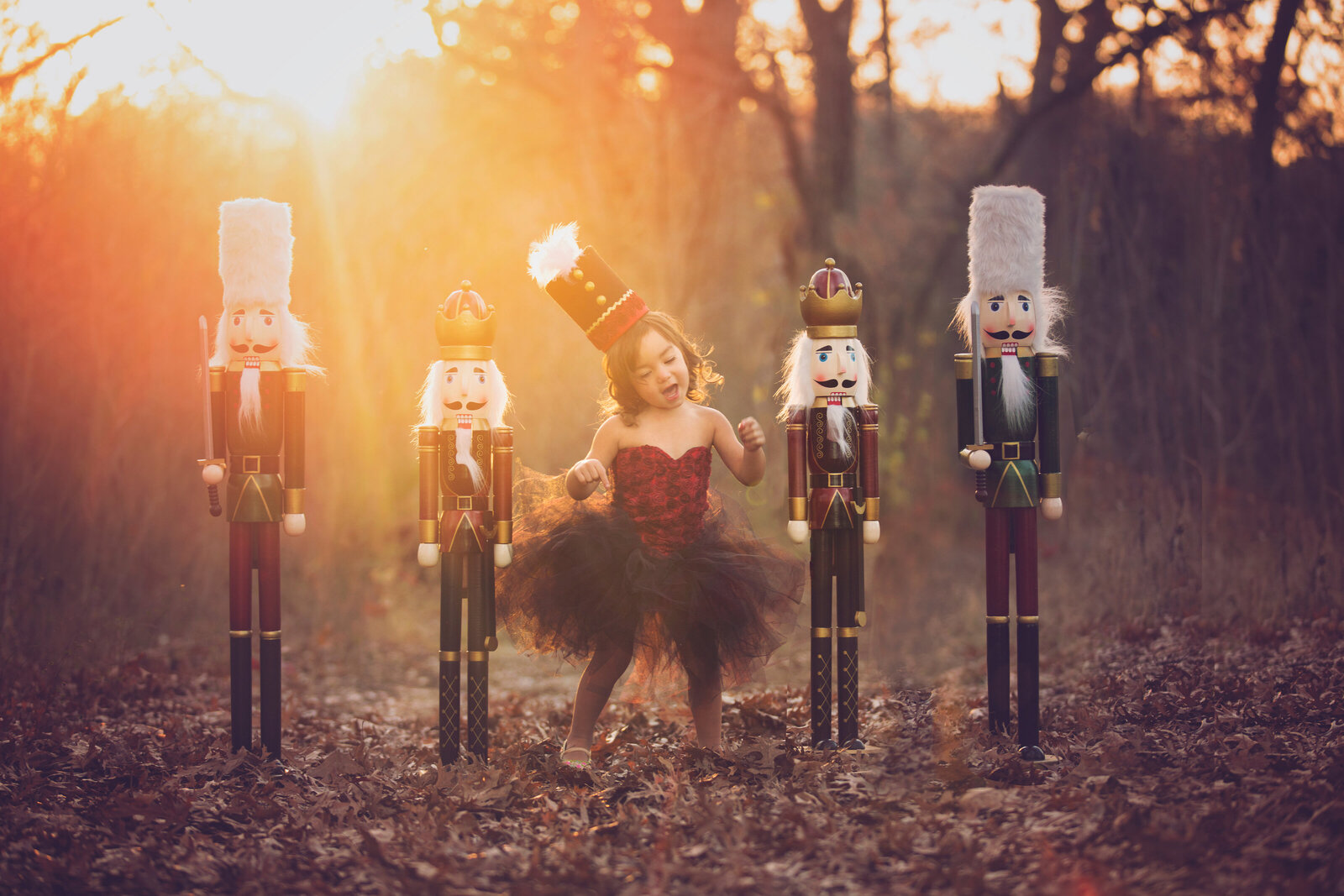 Toddler dancing with Christmas nutcrackers, a Dallas Photoshoot