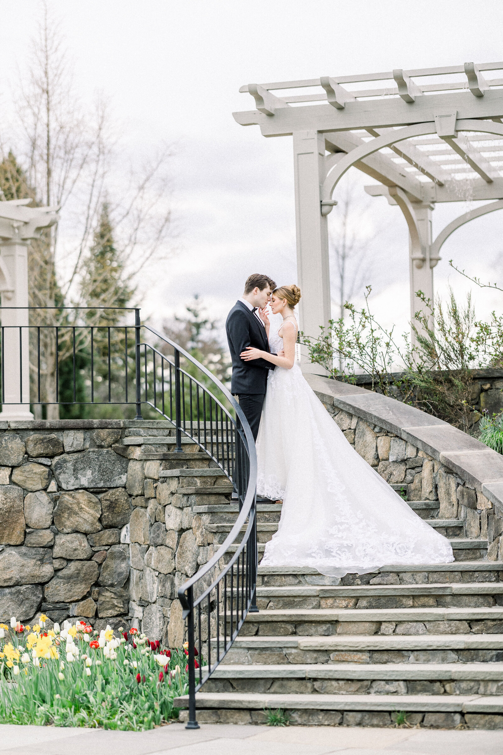 bride and groom kiss on grand staircase 