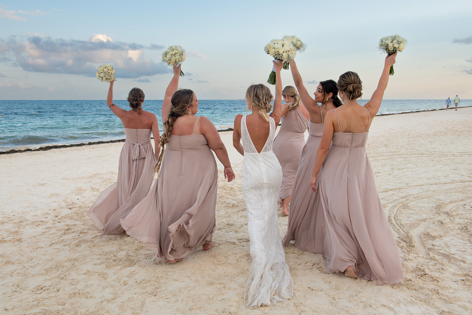 Bridesmaids celebrating on the beach before the wedding ceremony, captured during a destination wedding by CMH Studios