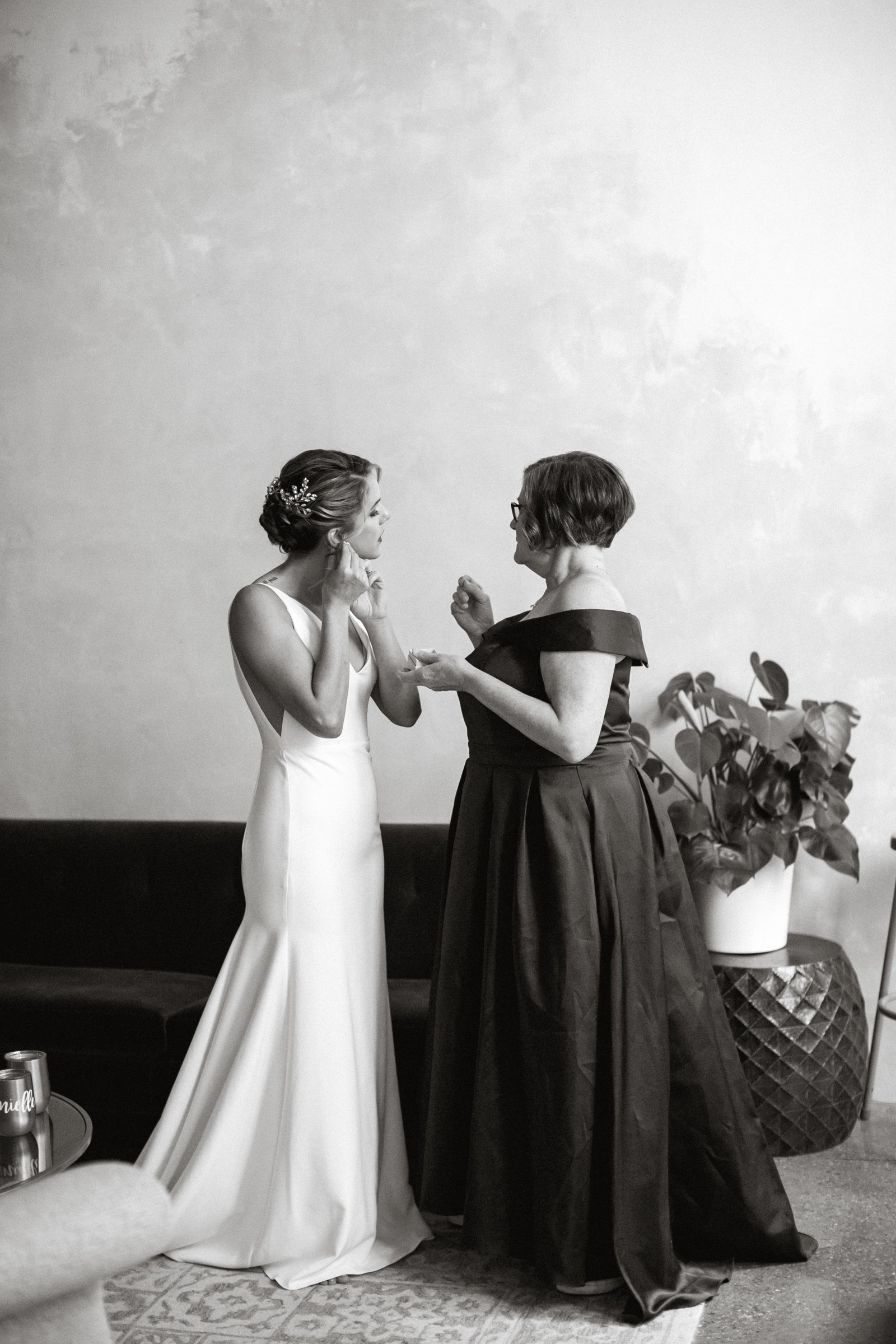 Bride getting ready with assistance from her mom,  in this unique wedding venue.
