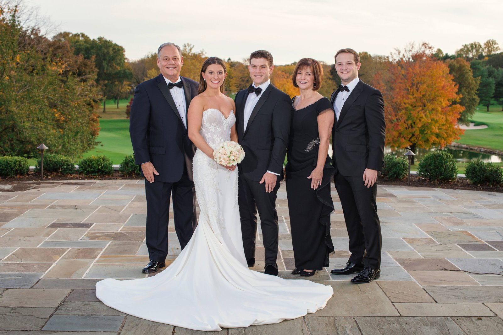 bride and groom with family outside Glen Head Country Club