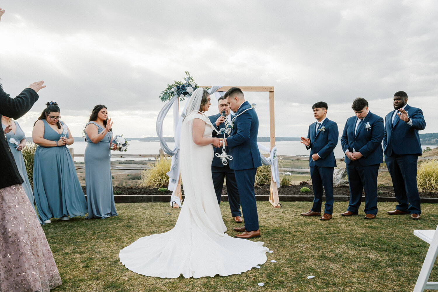 Bride and groom bow their heads.