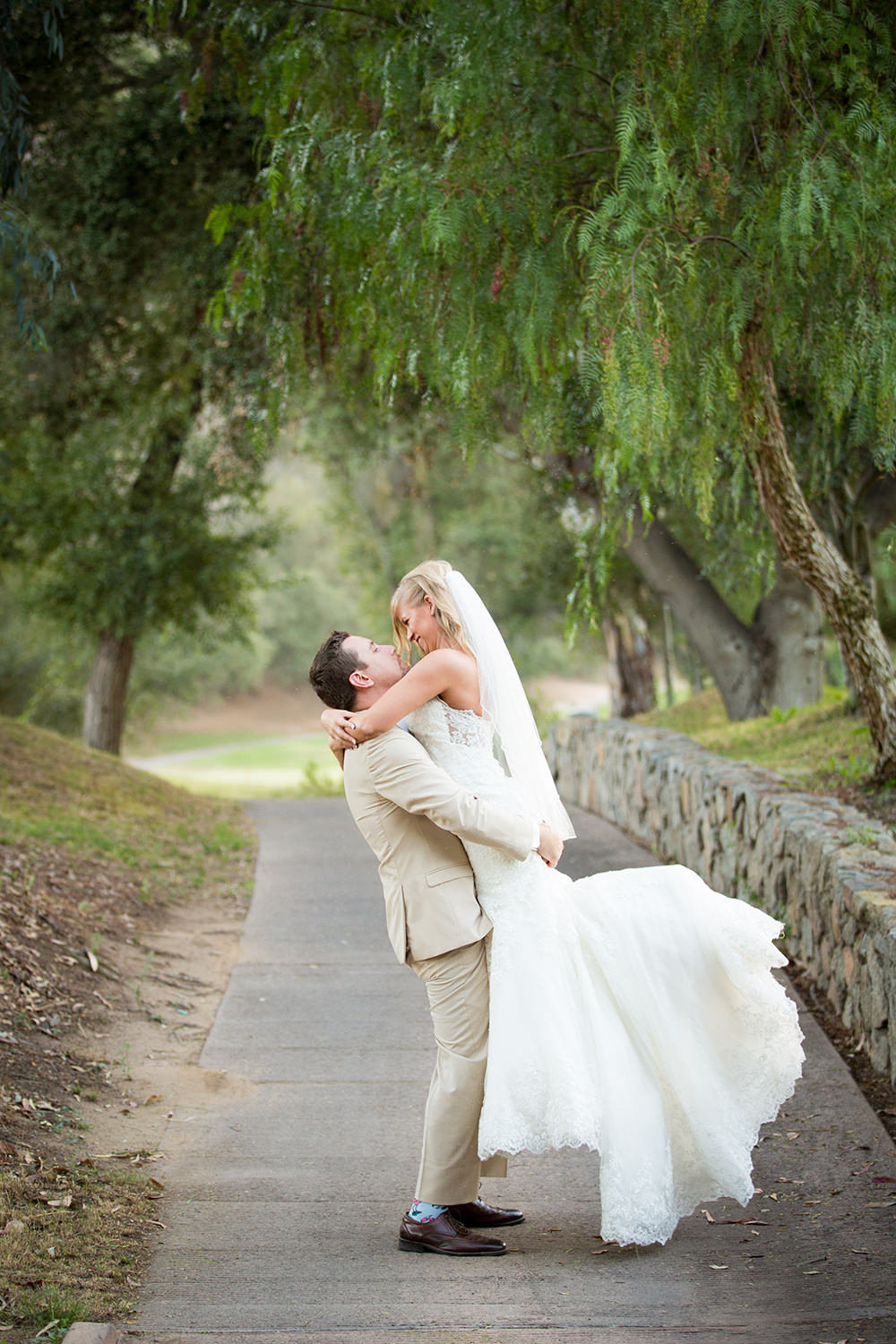 groom lifting bride off her feet