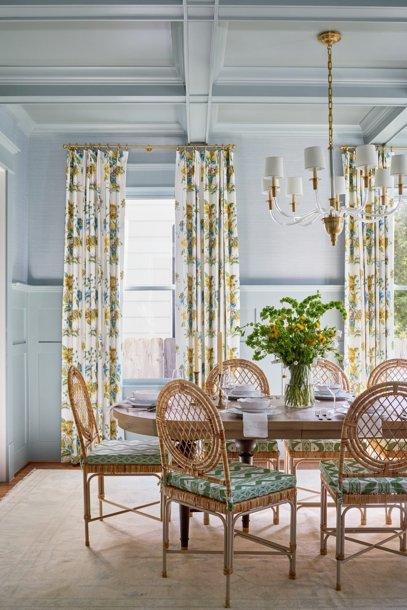 vision and hammer dining room with bright colorful floral curtains and wooden table