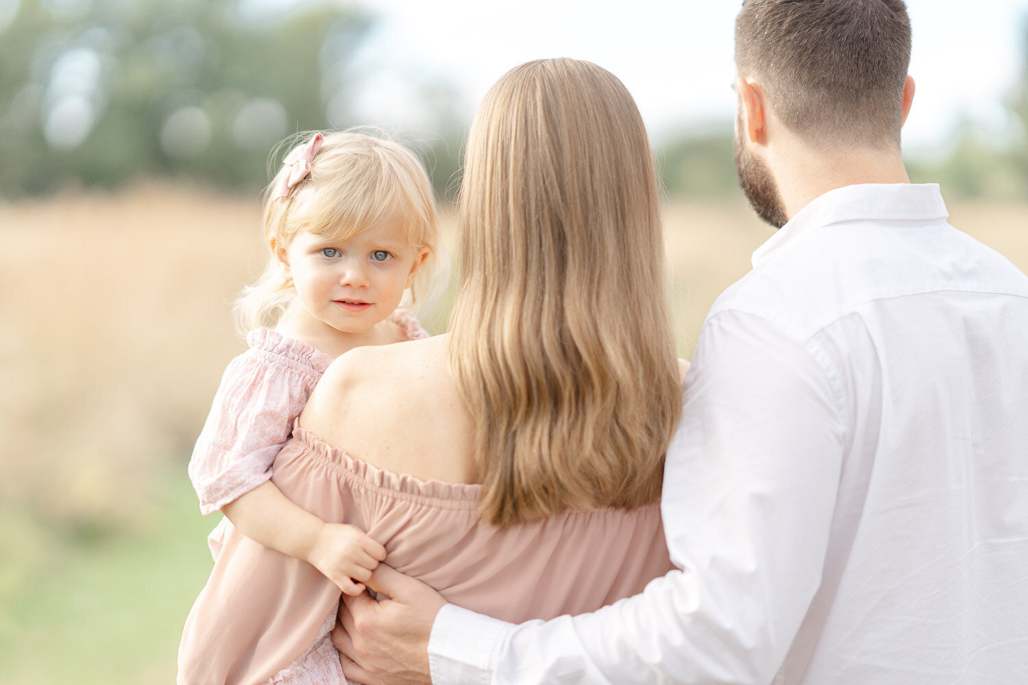 daughter held by mom during mini session Ashburn, Virginia
