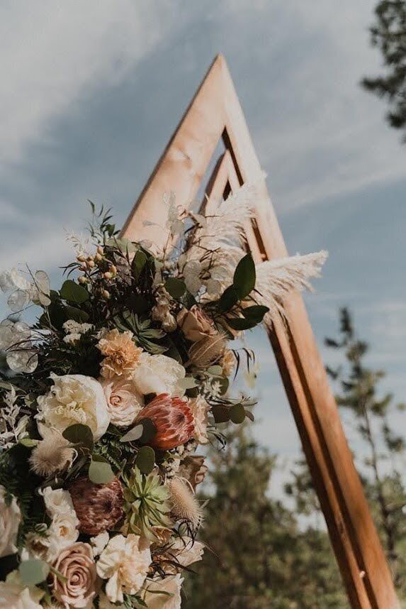Boho inspired wedding floral arch representing wedding flower packages available..