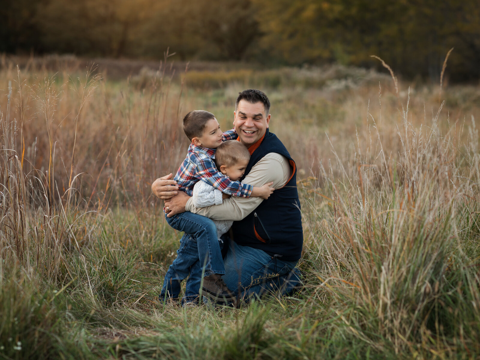 dad holding his two sons for family photos 