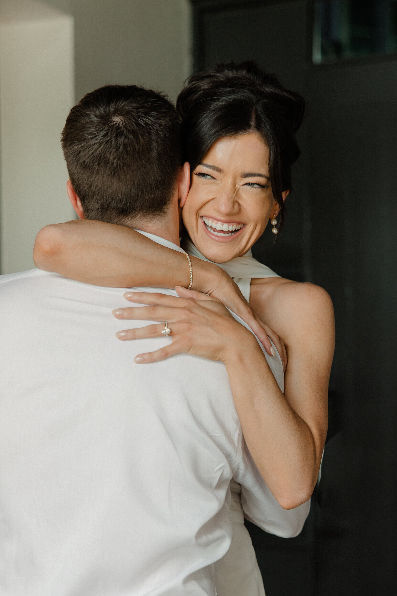 Bride hugging groom