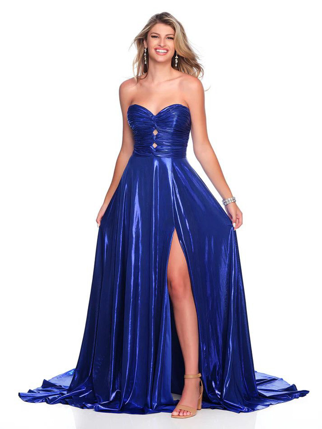 Woman wearing a strapless royal blue gown with a high slit posing indoors